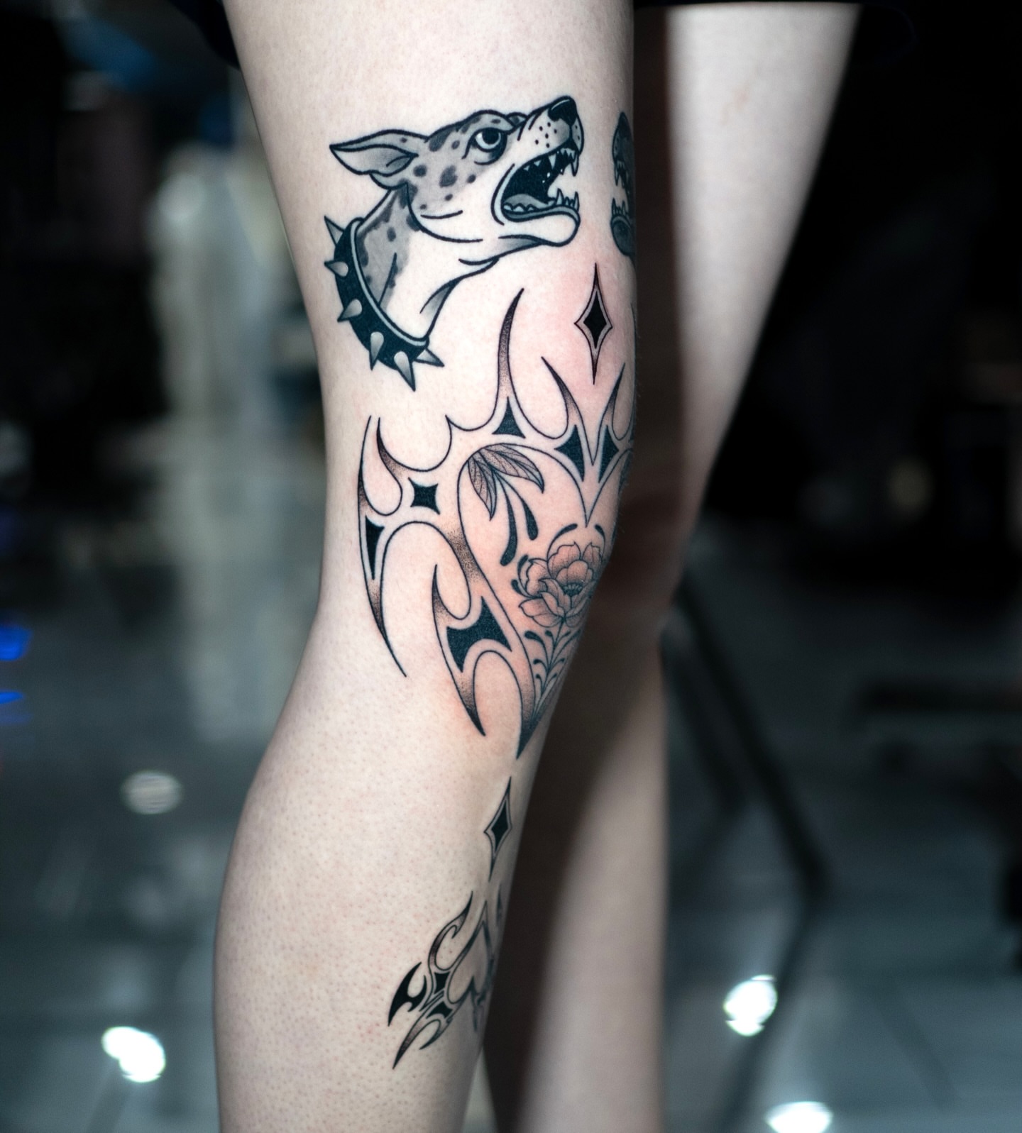 Dog and floral tribal tattoo on the calf by Jorden Ruppe