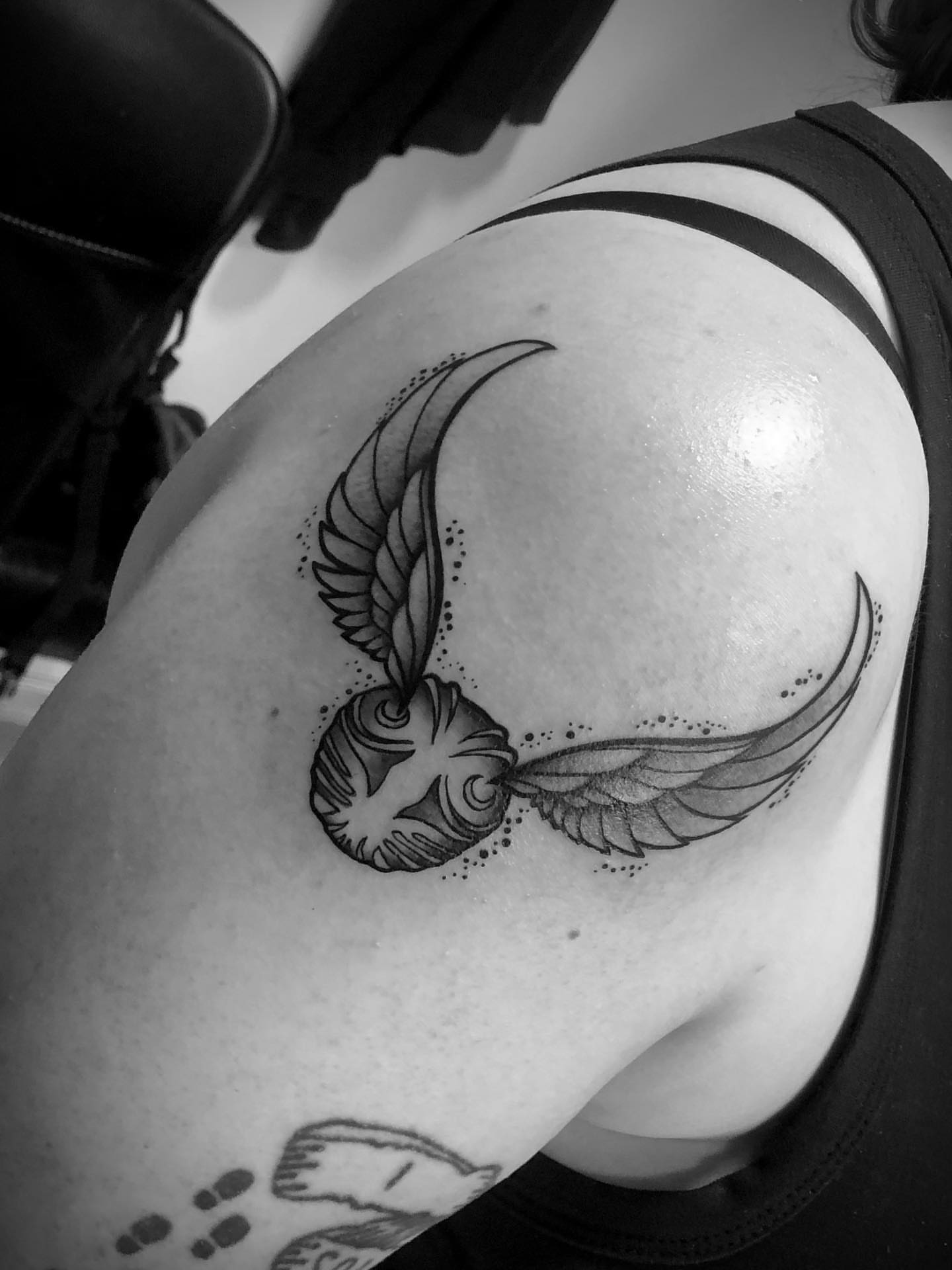 Golden snitch dotwork tattoo on the shoulder by Ink of Winchester