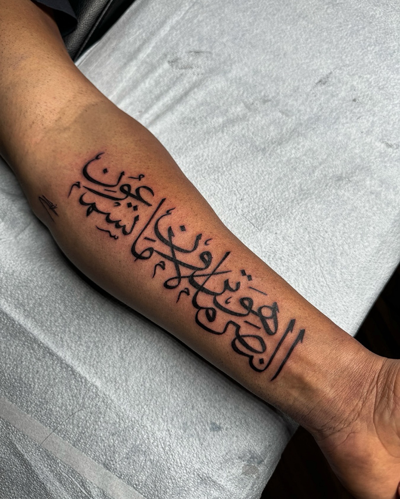 Arabic calligraphy lettering script tattoo on the forearm by Montreal Tattoo Artist