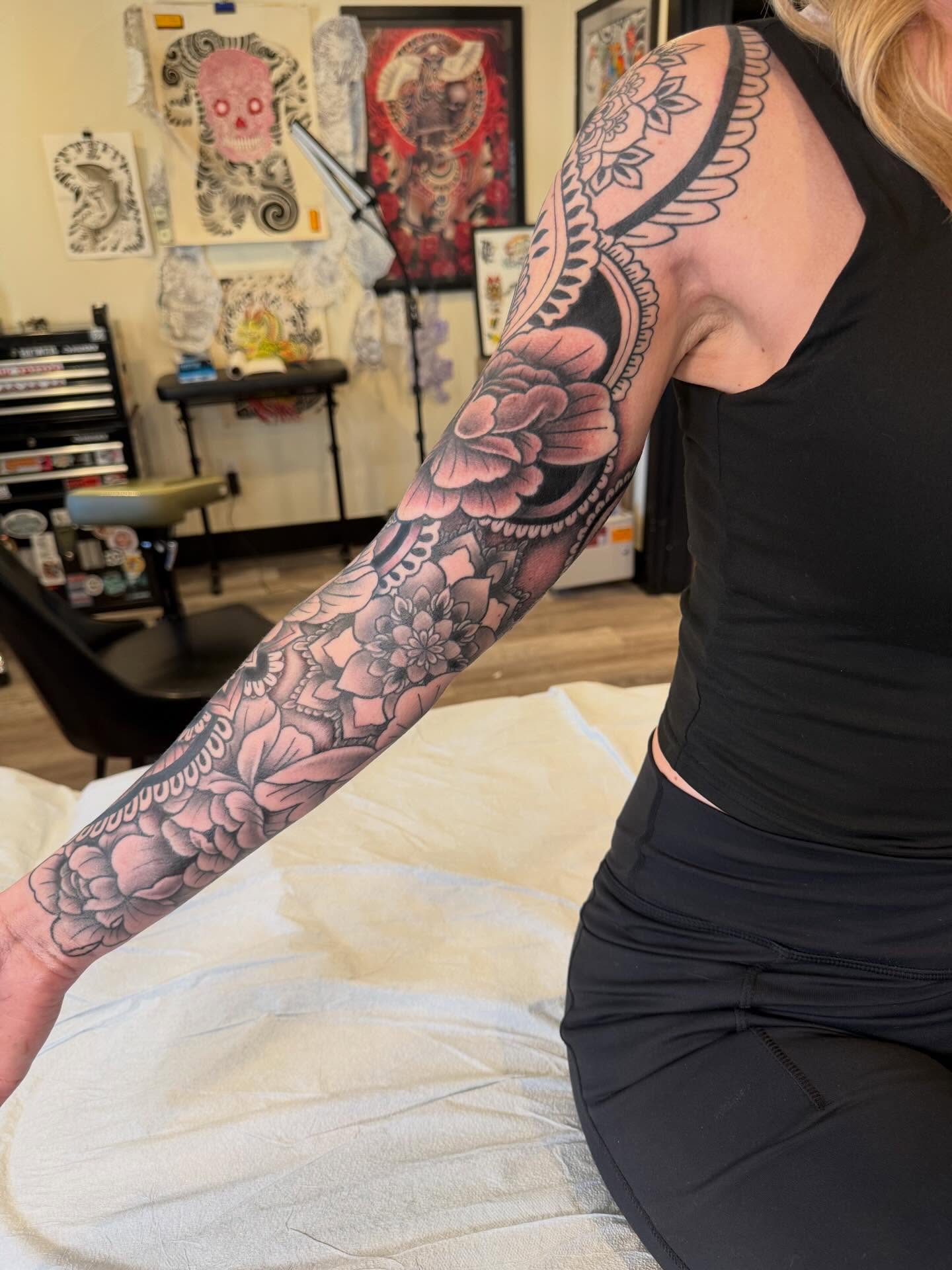 Floral sleeve American traditional tattoo on the upper arm by Rebecca Basma Smith