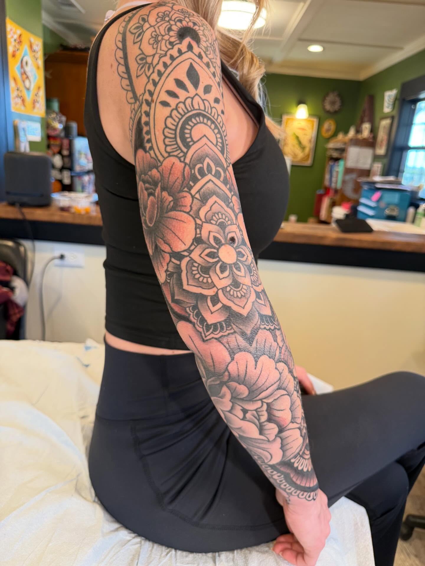 Floral mandala geometric tattoo on the upper arm by Rebecca Basma Smith