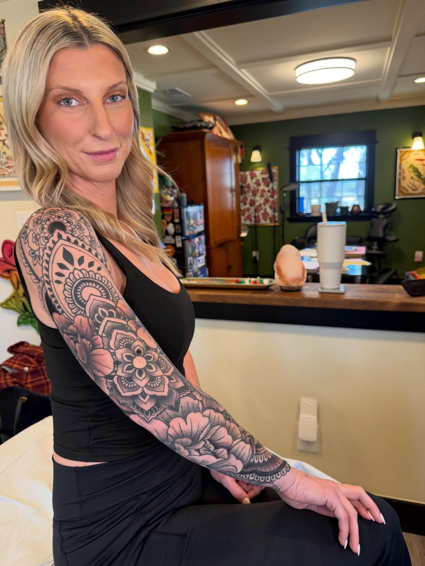 Floral mandala geometric tattoo on the upper arm by Rebecca Basma Smith