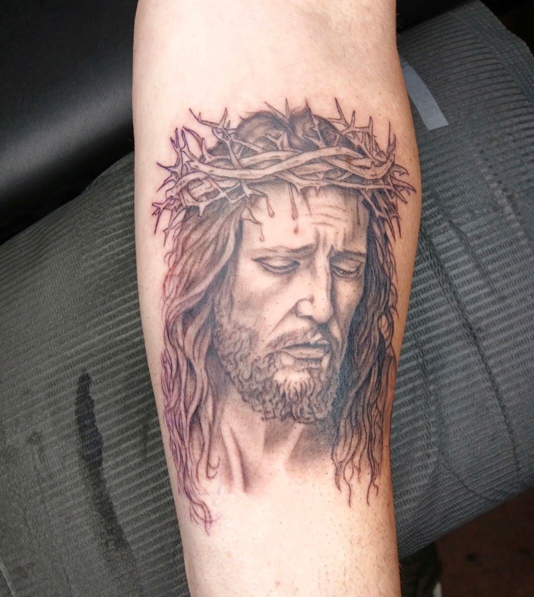 Jesus Christ realism tattoo on the forearm by Chris Bell