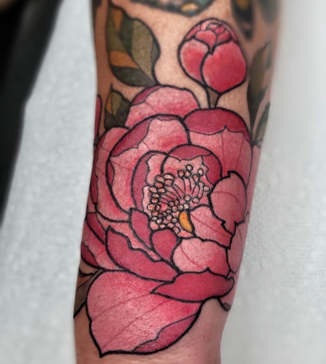 Peony watercolor tattoo on the forearm by Chris Bell
