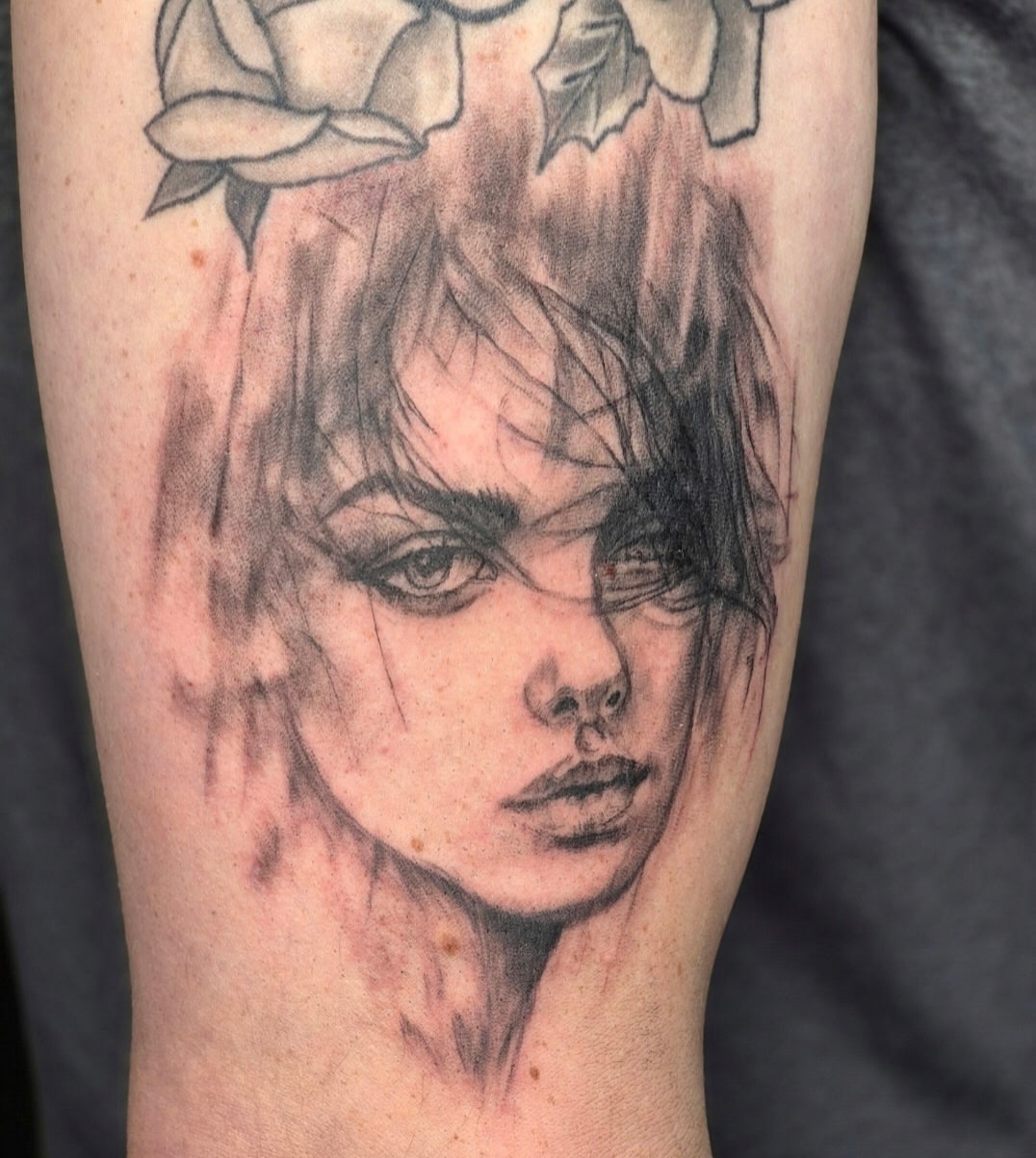 Woman's face realism tattoo on the forearm by Chris Bell