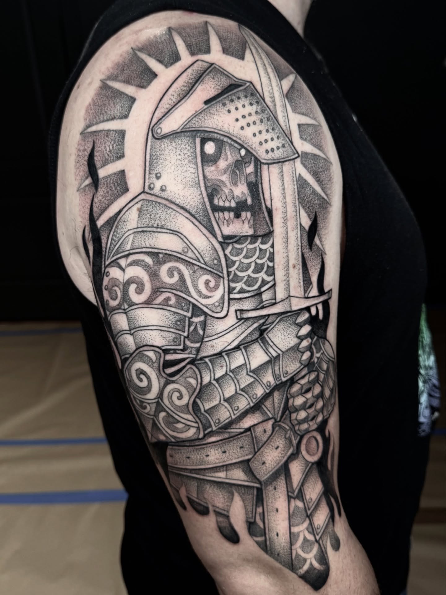 Knight armor dotwork tattoo on the shoulder by Miles Romero Smith