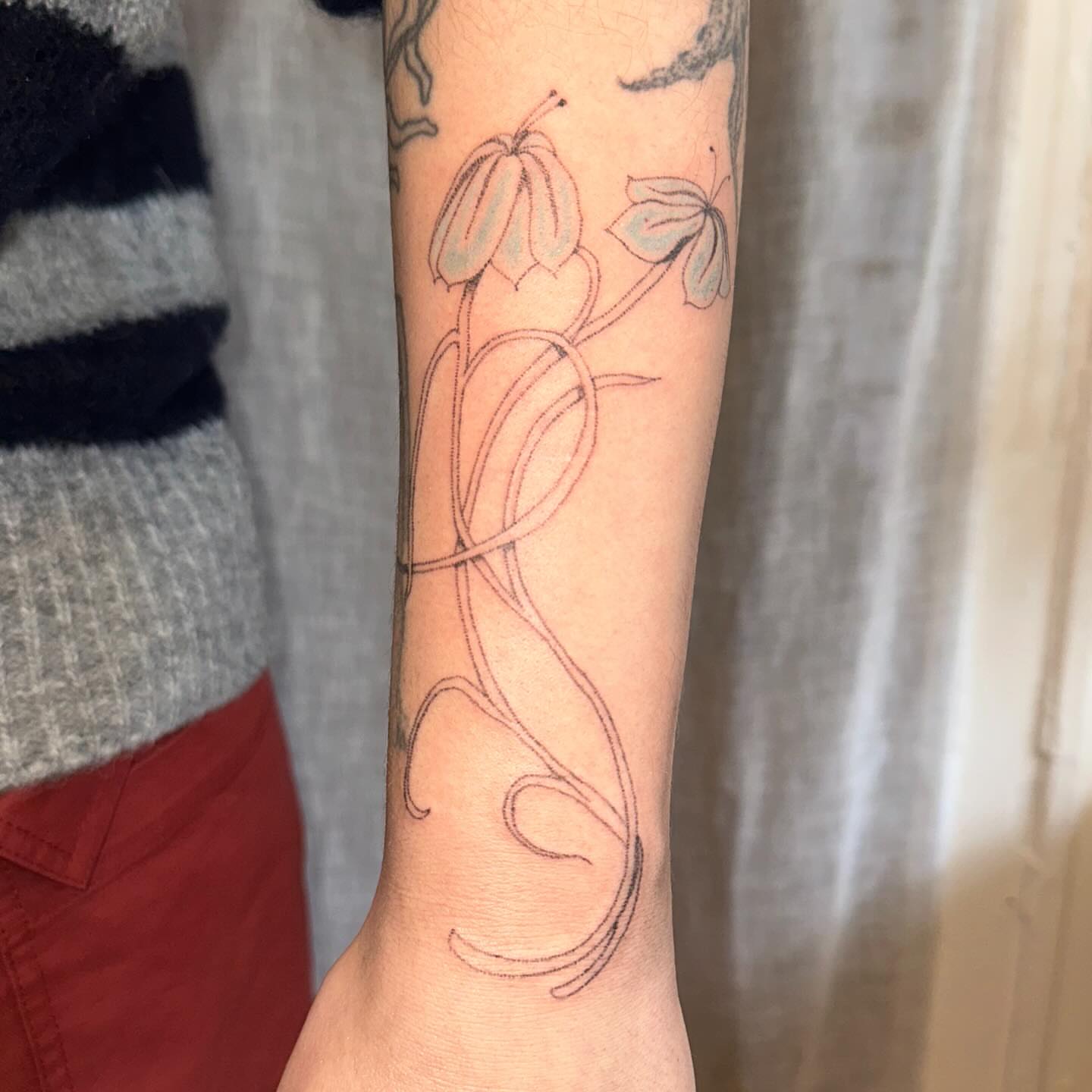 Floral design fine line tattoo on the forearm by kate