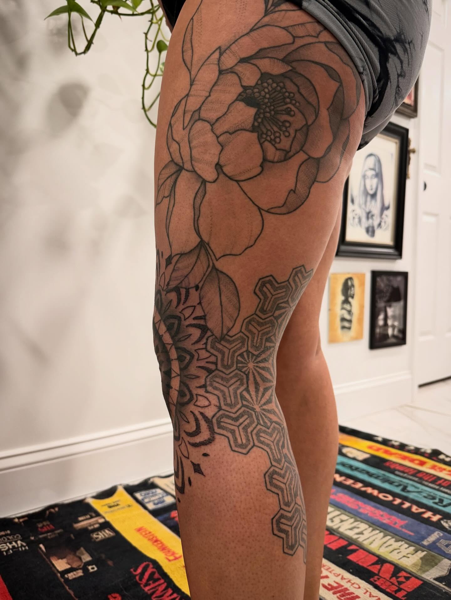 Floral design geometric tattoo on the thigh by Shannon Misitano