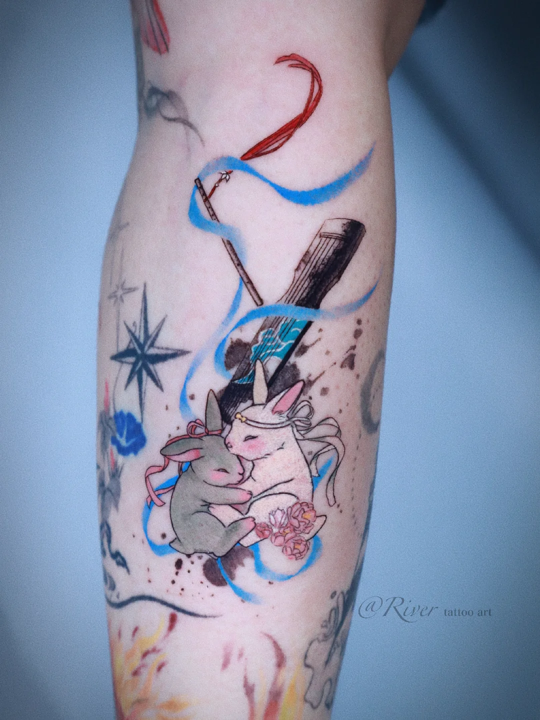 Unicorns and musical instruments watercolor tattoo on the forearm by River