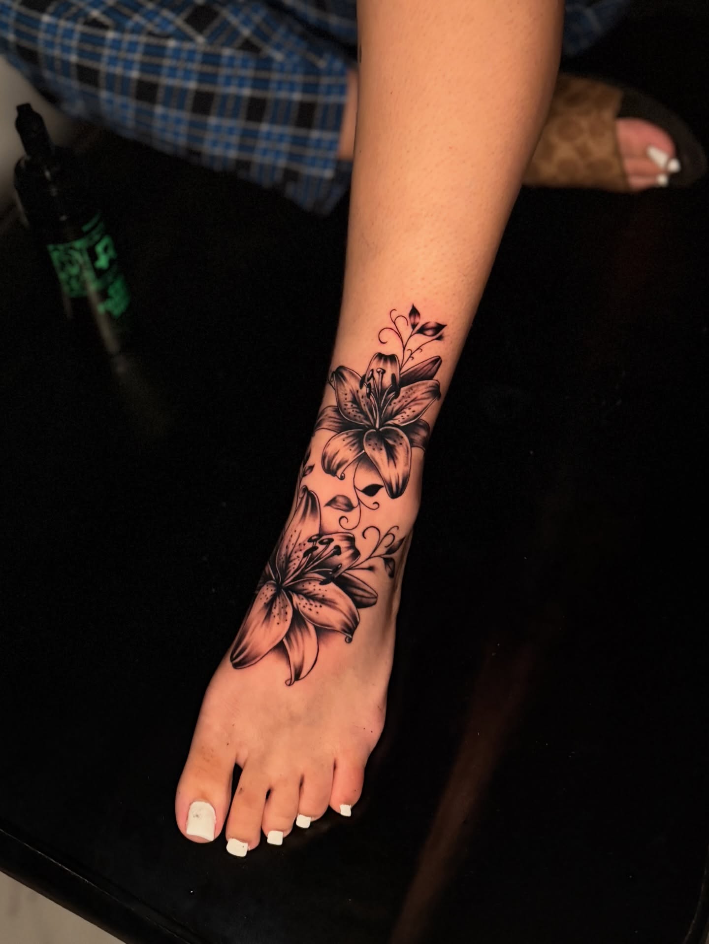 Lily flowers black and grey tattoo on the foot by InkbyCasillas