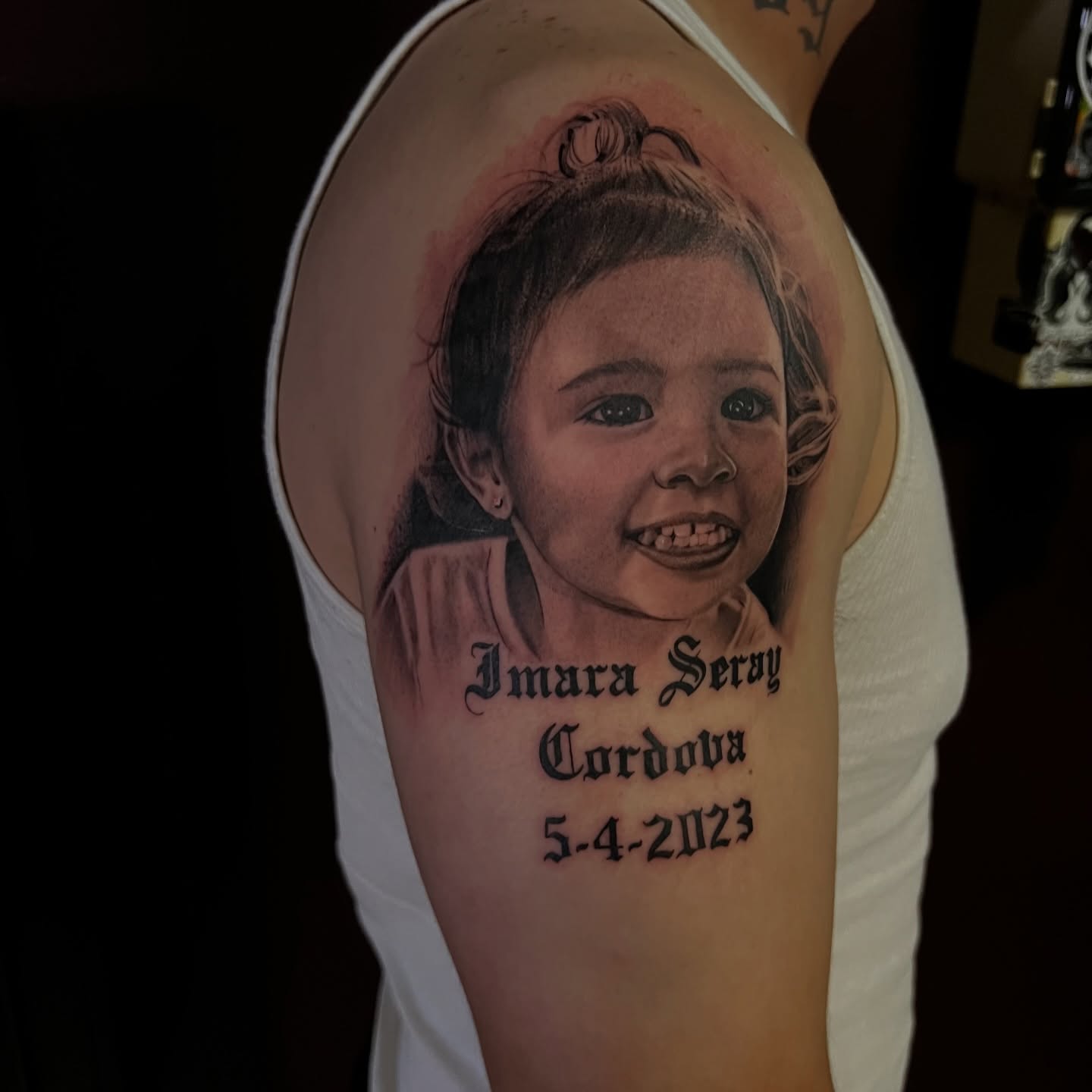 Child portrait realism tattoo on the shoulder by Nick Ochoa