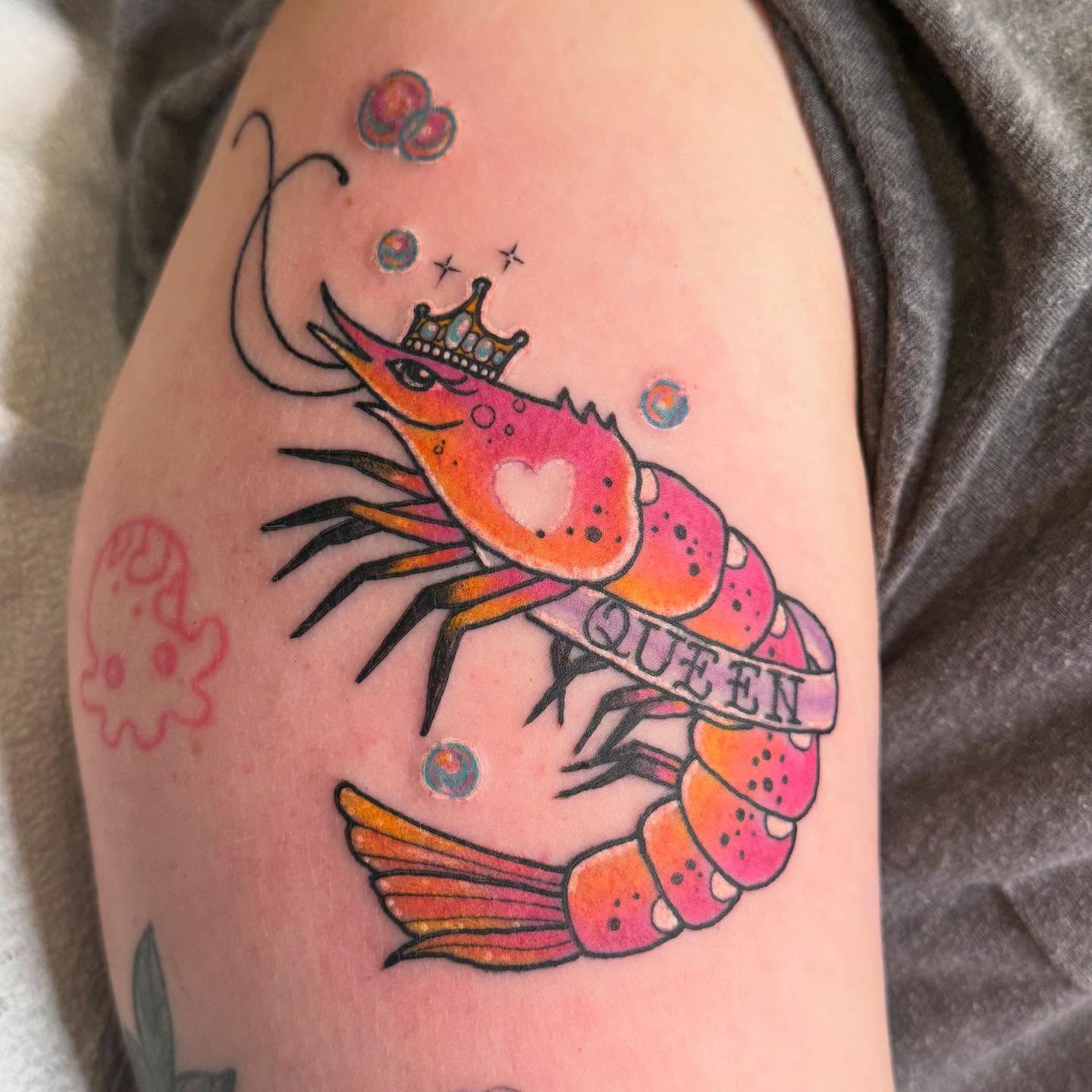 Prawn with crown new school tattoo on the upper arm by Jacie Aasen-Lupino