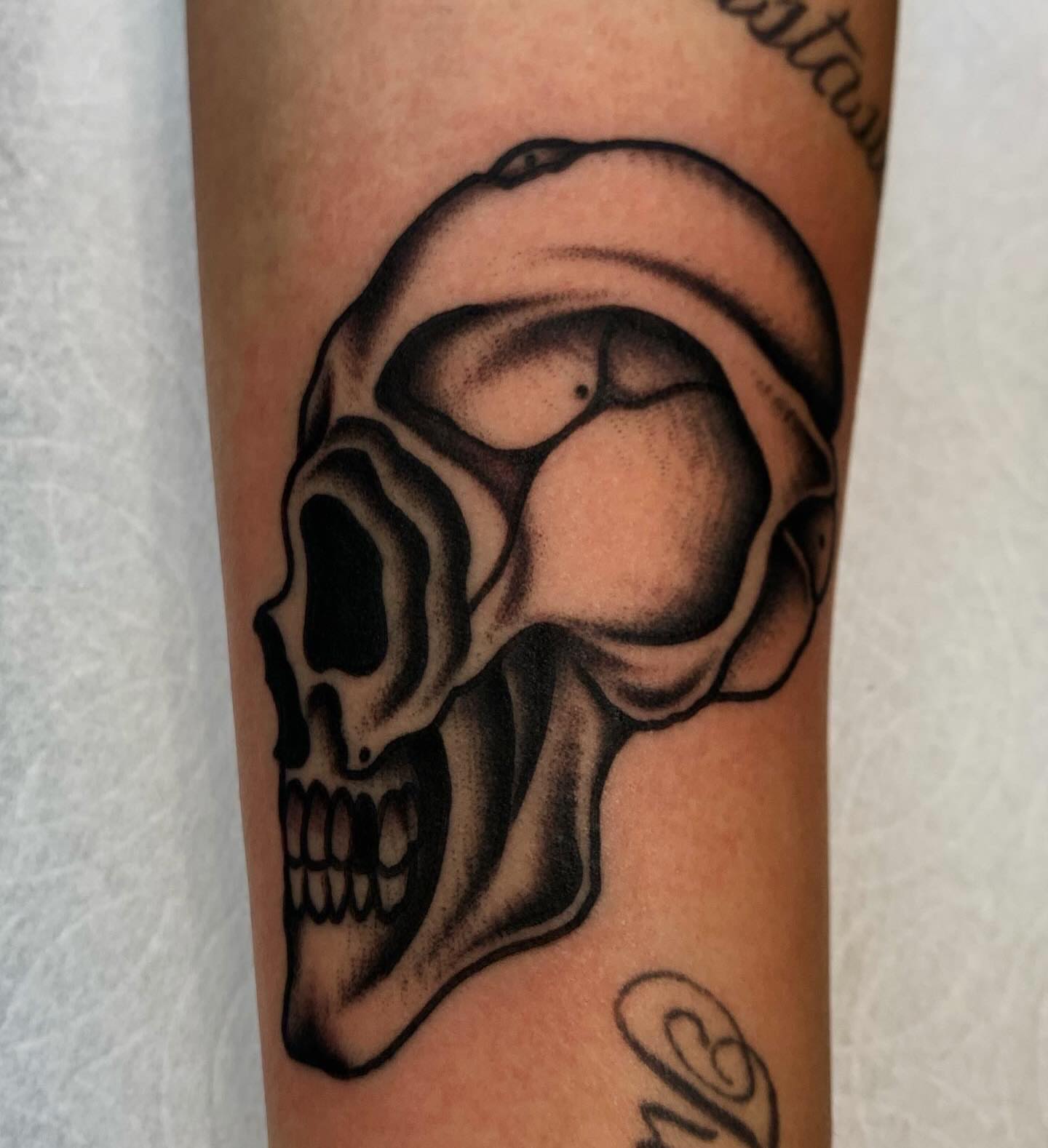 Skull black and grey tattoo on the forearm by Brandon Heredia, Vacaville, California