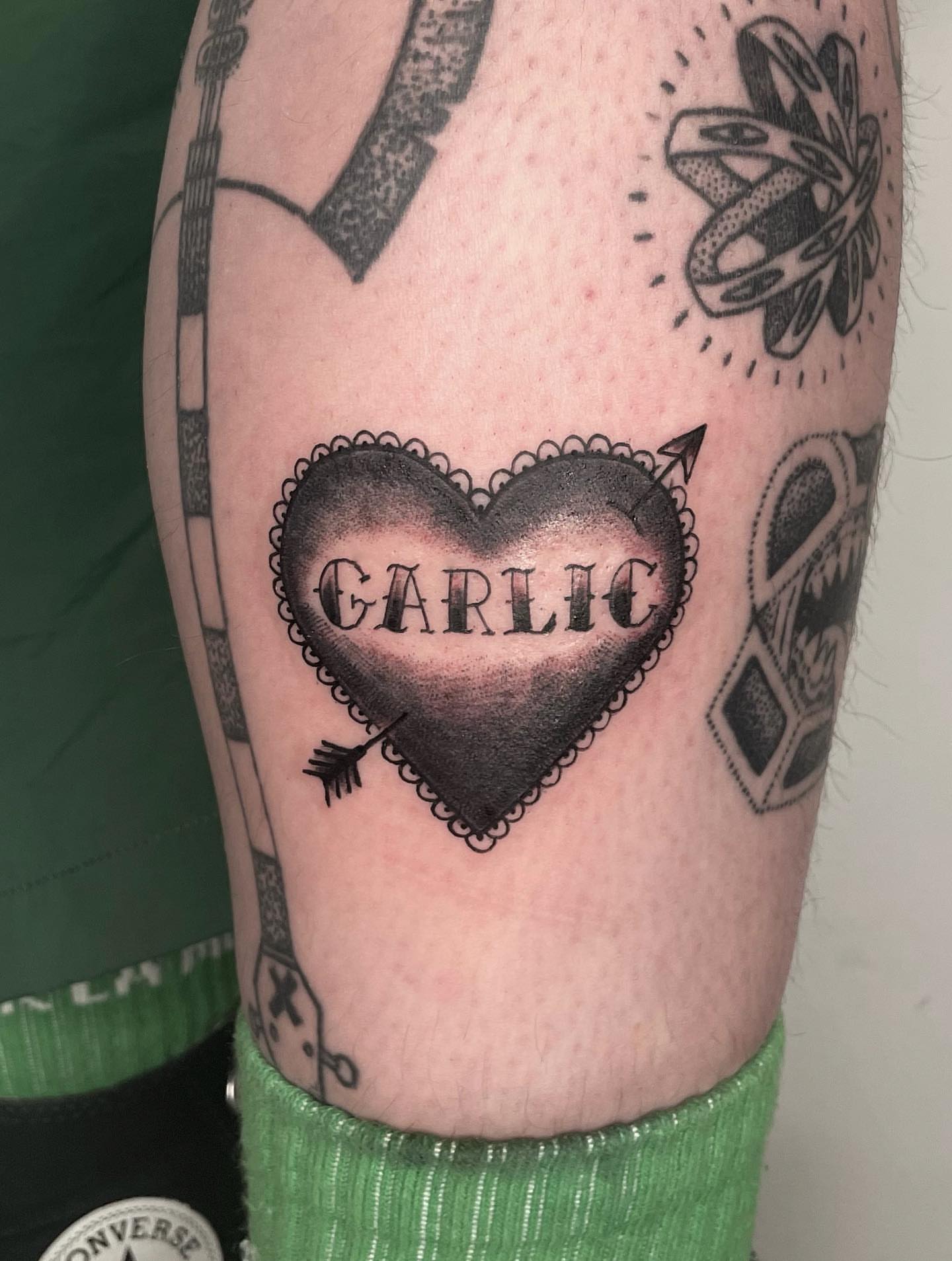 Heart with arrow black and grey tattoo on the forearm by Fin :