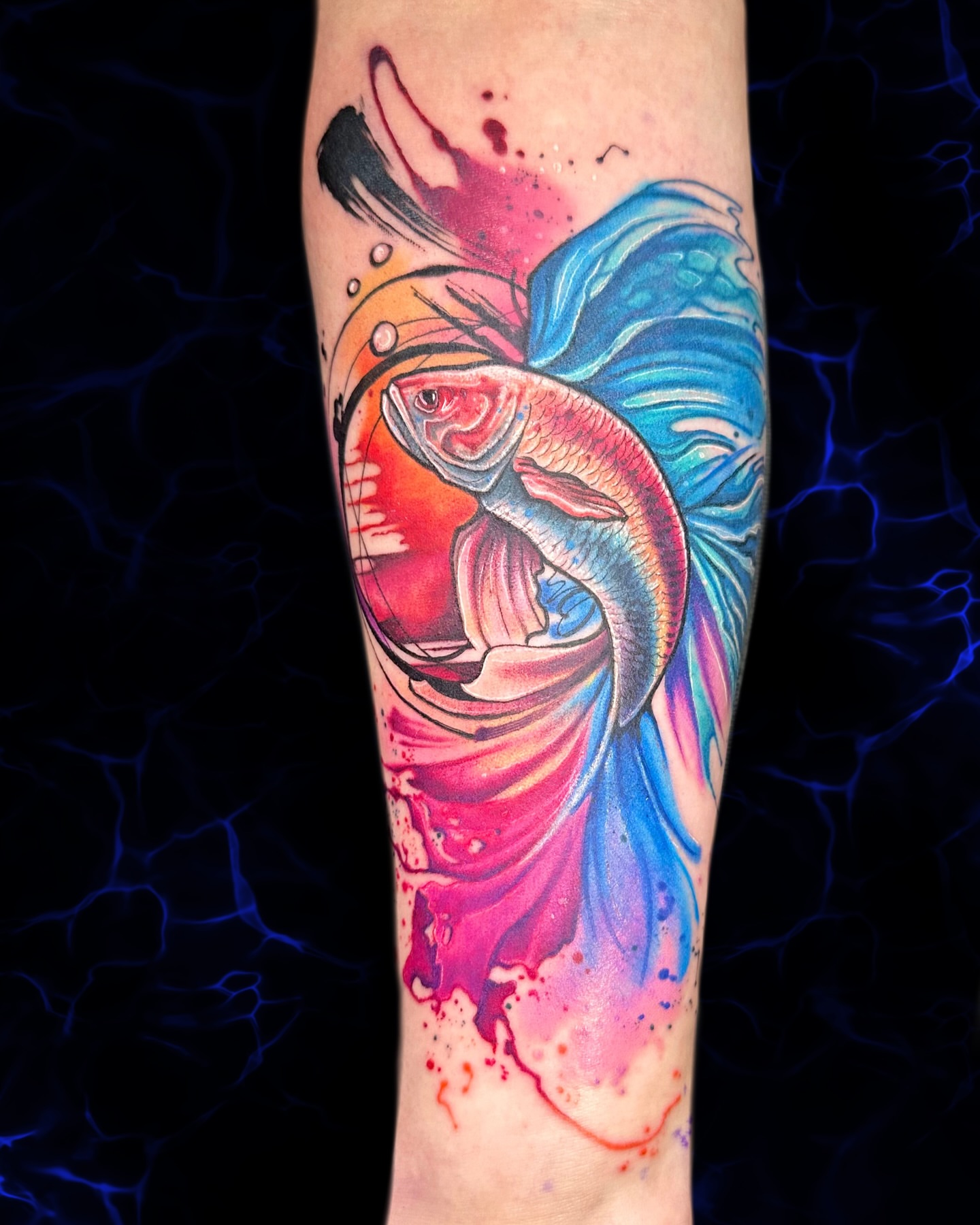 Fish watercolor tattoo on the forearm by Alena Petunia