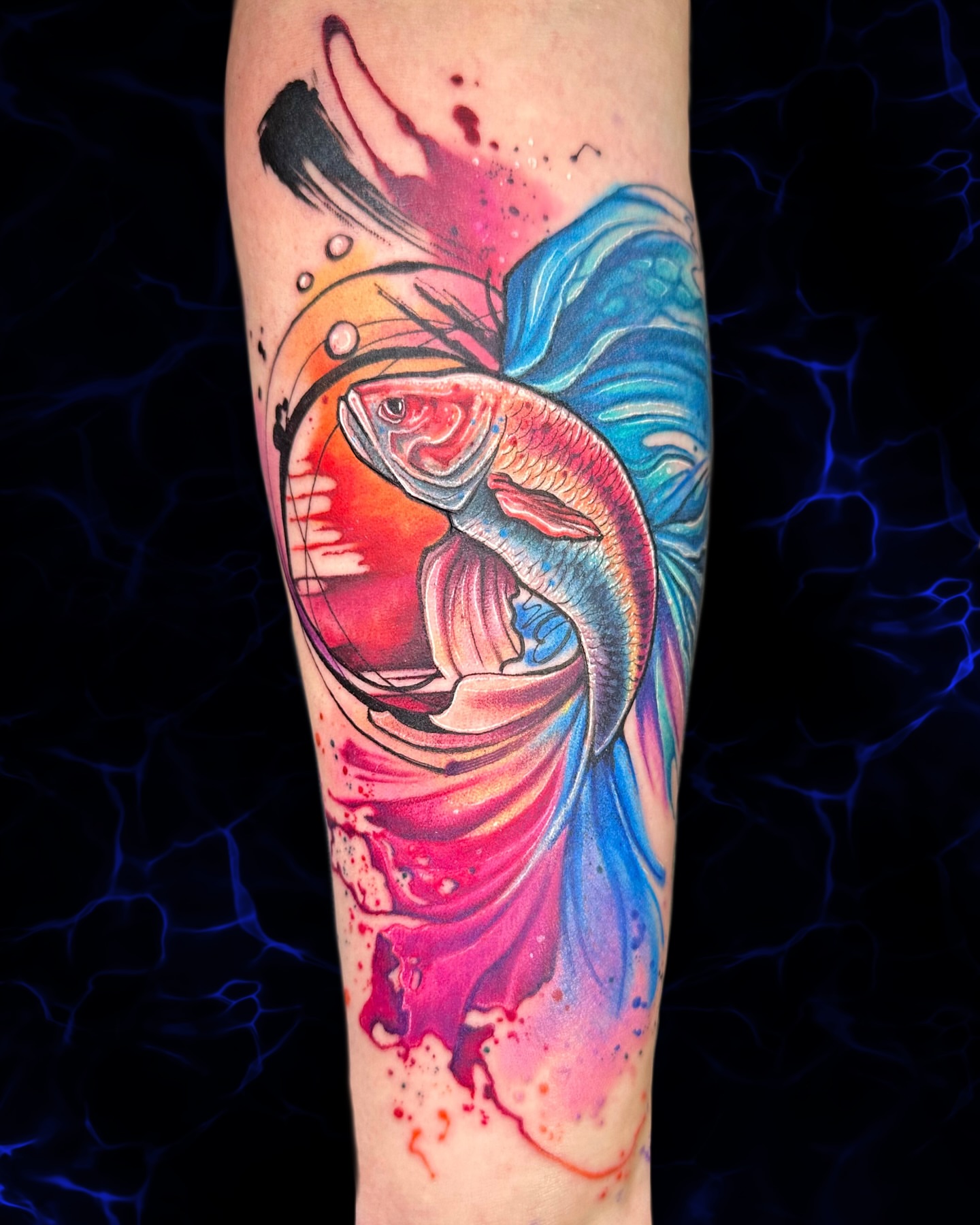 Fish watercolor tattoo on the forearm by Alena Petunia