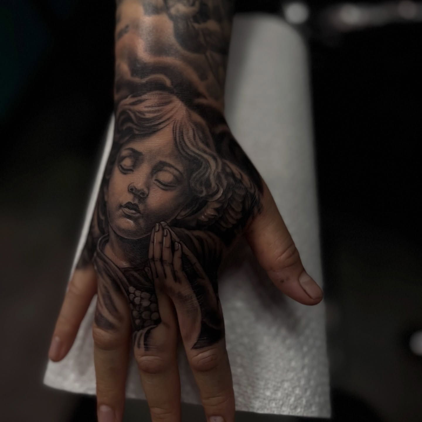 Praying child realism tattoo on the hand by Tony Hernandez, Chicago, Illinois