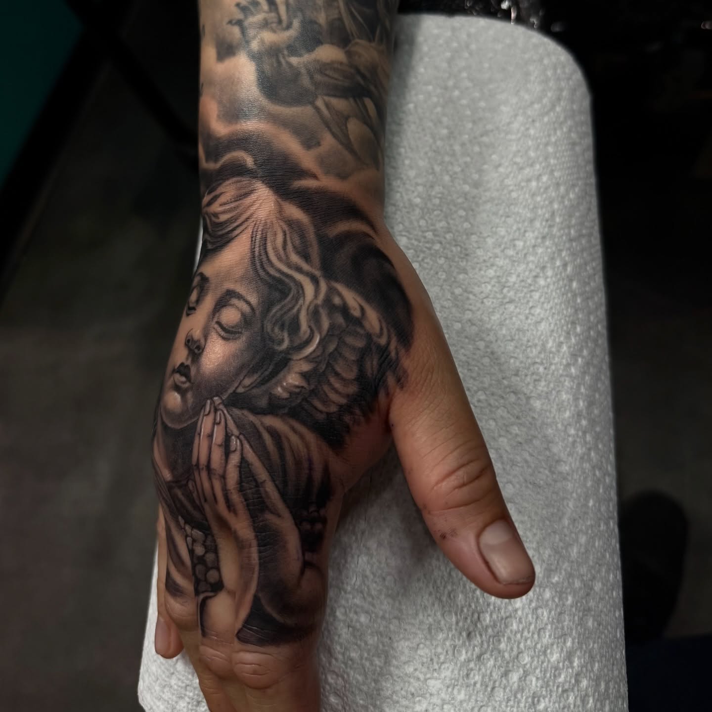 Praying angel realism tattoo on the hand by Tony Hernandez, Chicago, Illinois