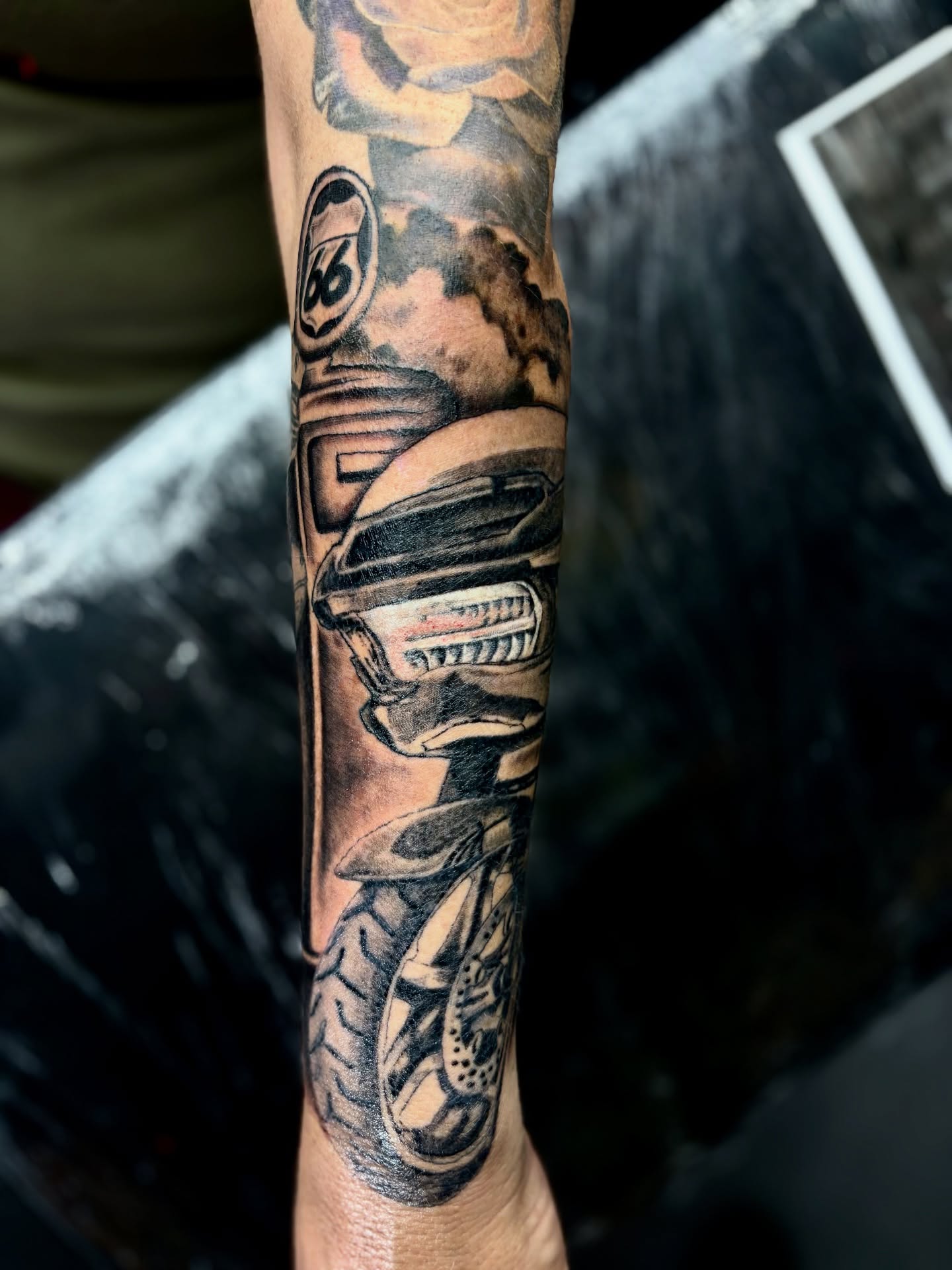 Motorcycle black and grey tattoo on the forearm by Deacon Moser