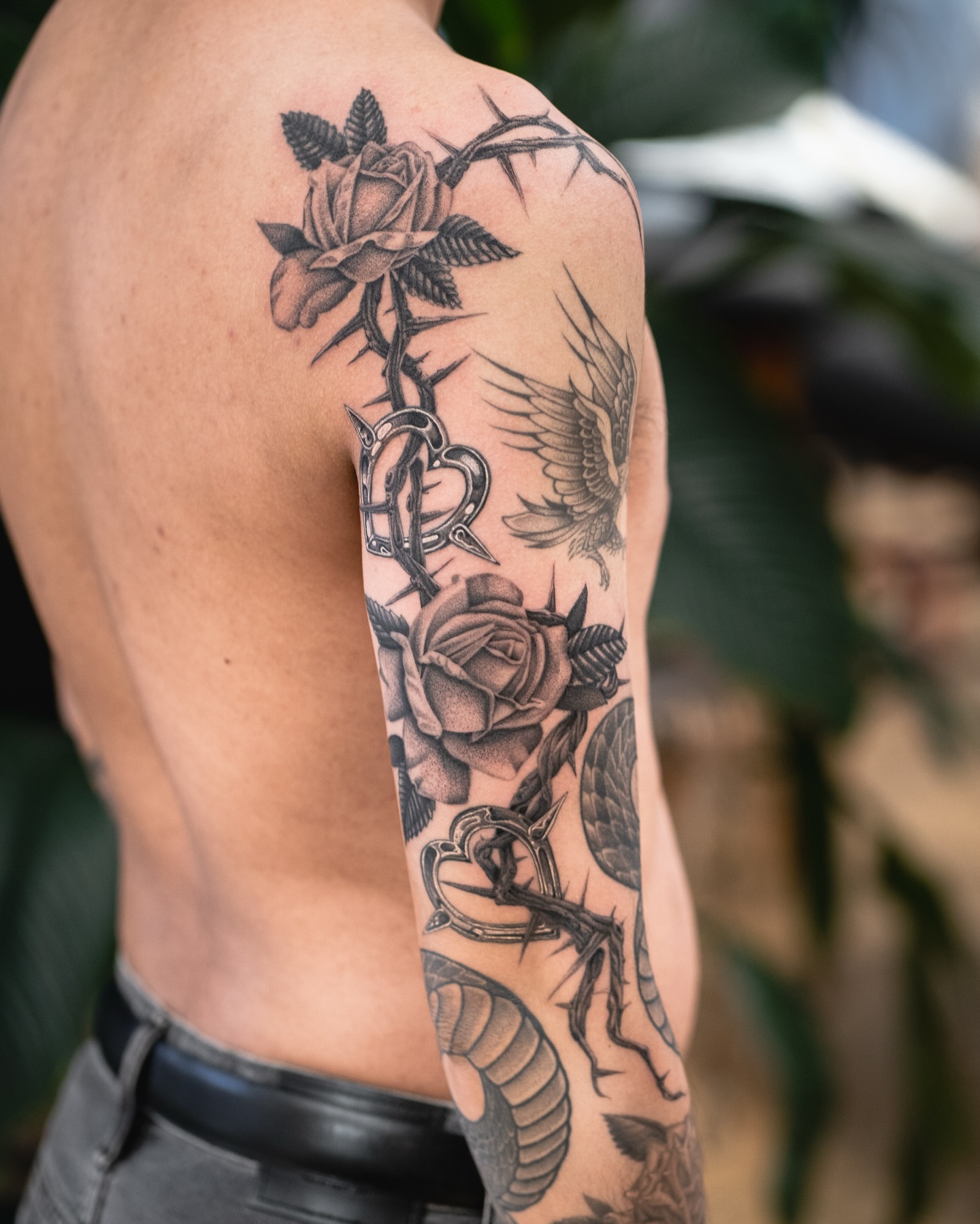 Roses and thorns realism tattoo on the upper arm by James Fernella, San Francisco, California