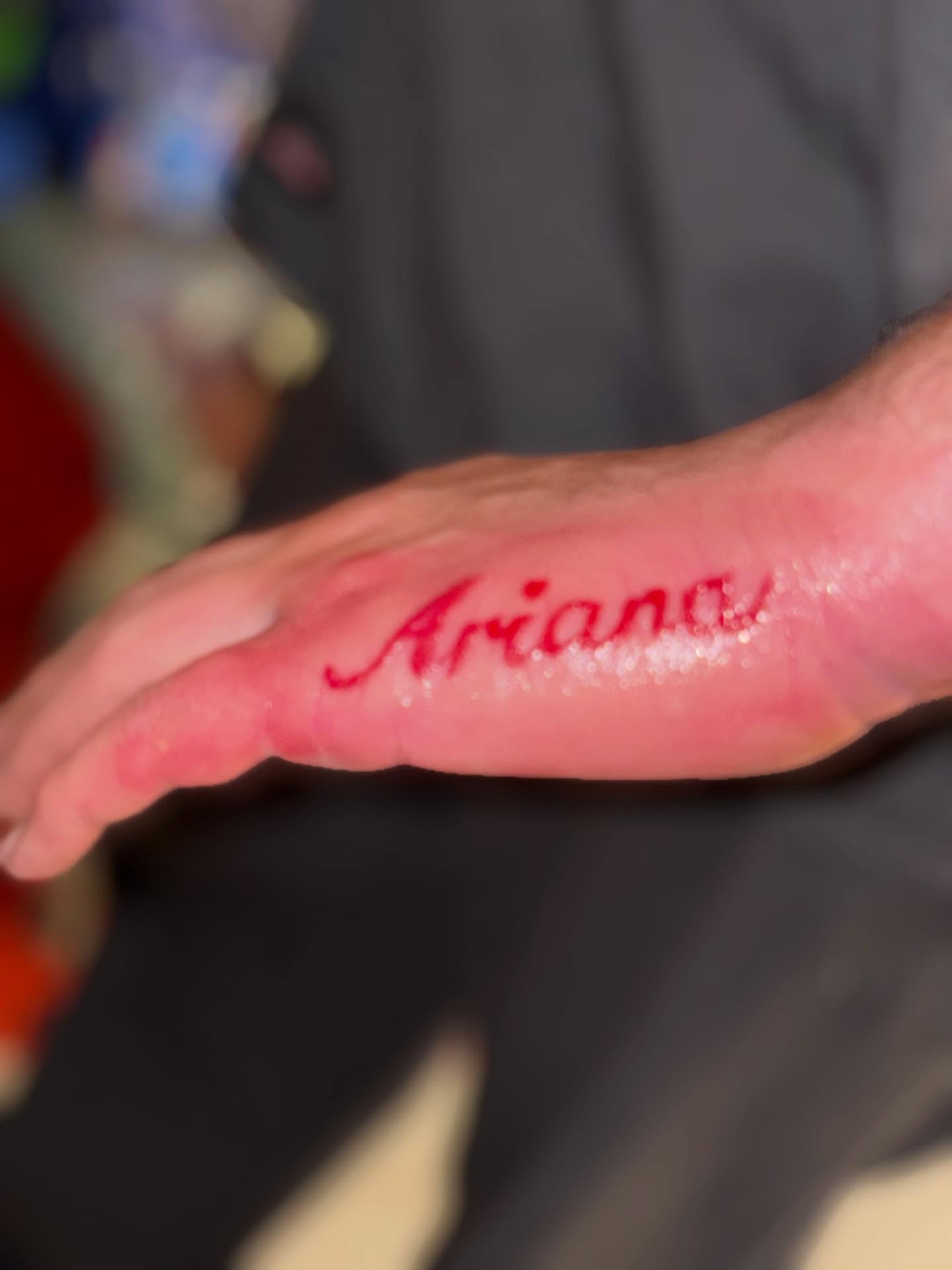 Ariana lettering script tattoo on the hand by TP