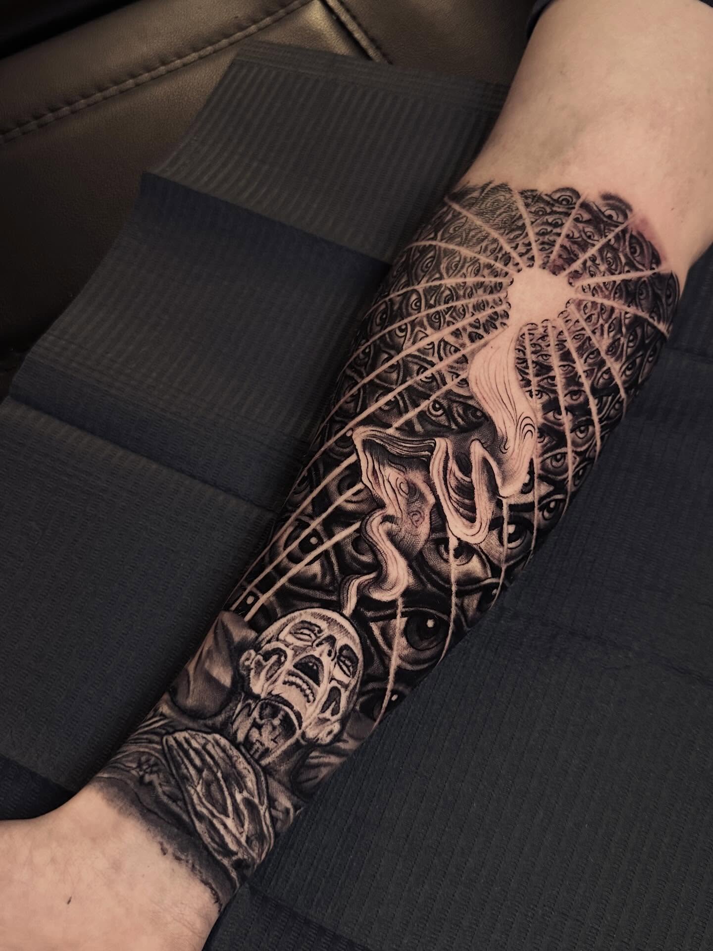 Surrealistic face surrealism tattoo on the forearm by Italo Holie