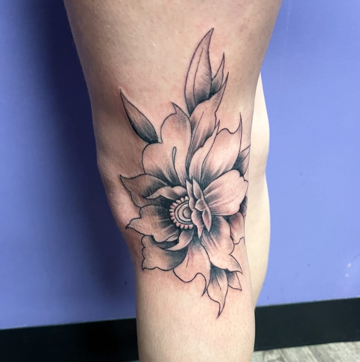 Flower black and grey tattoo on the thigh by Mark Calloway
