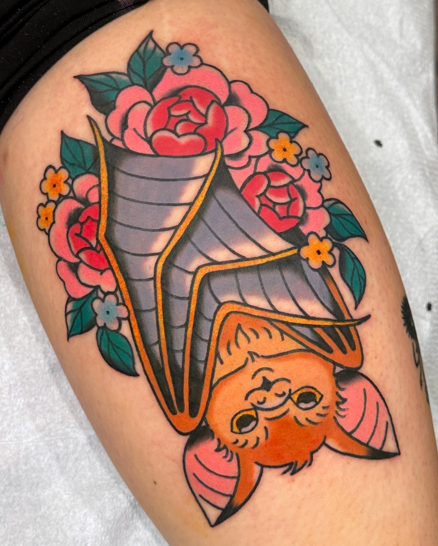 Bat and flowers American traditional tattoo on the thigh by Paige Ochoa