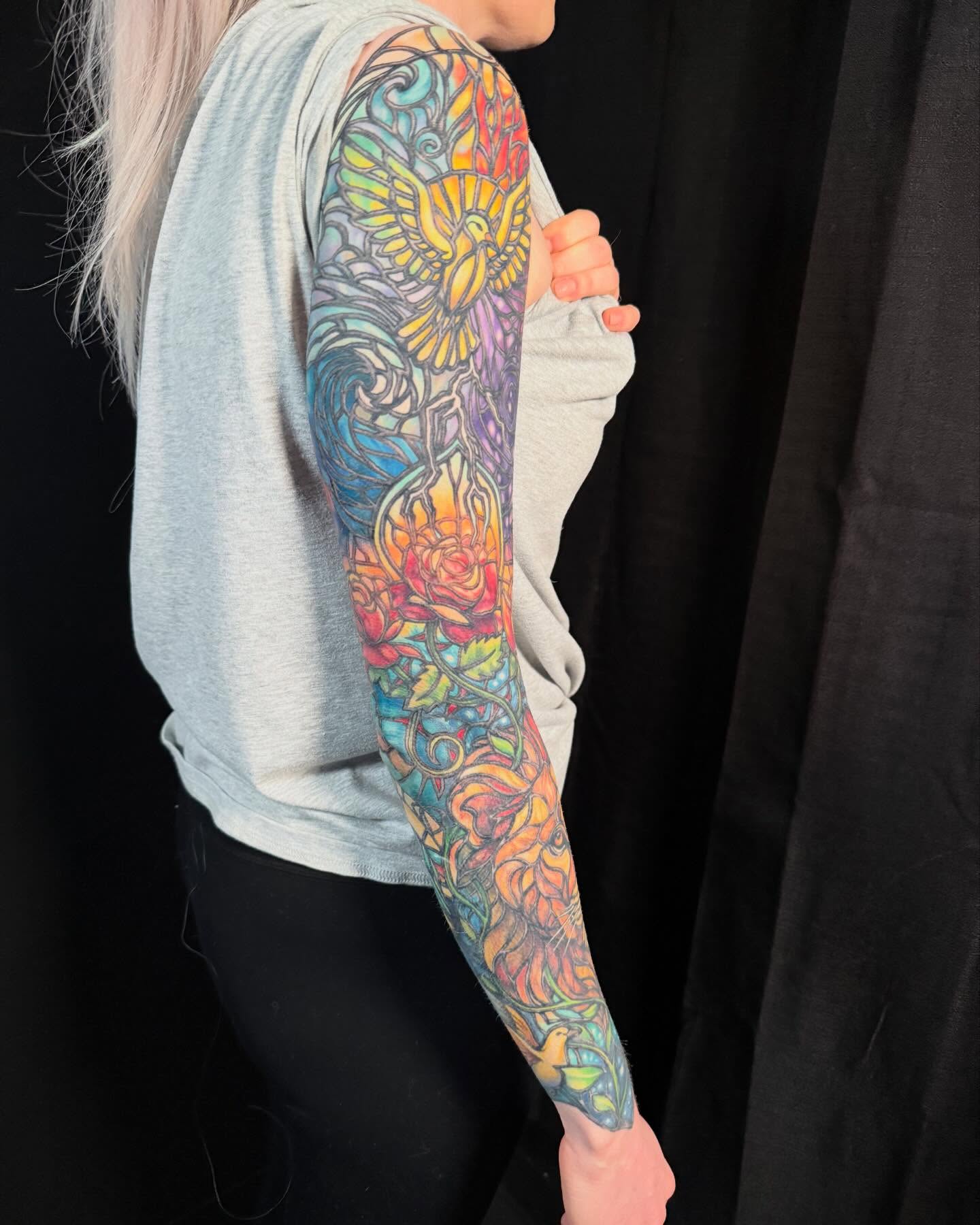 Floral and abstract design new school tattoo on the upper arm by Jade Lewis
