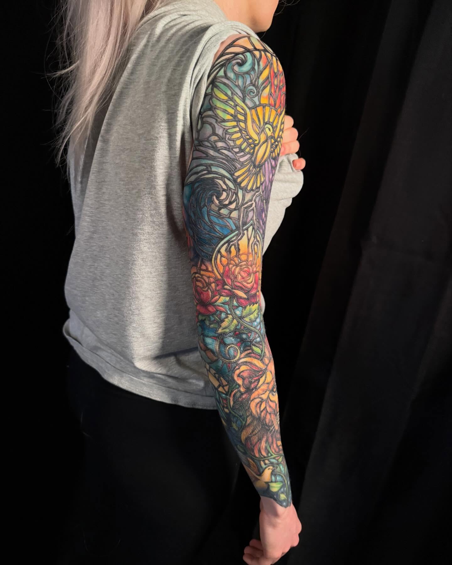 Floral bouquet new school tattoo on the upper arm by Jade Lewis
