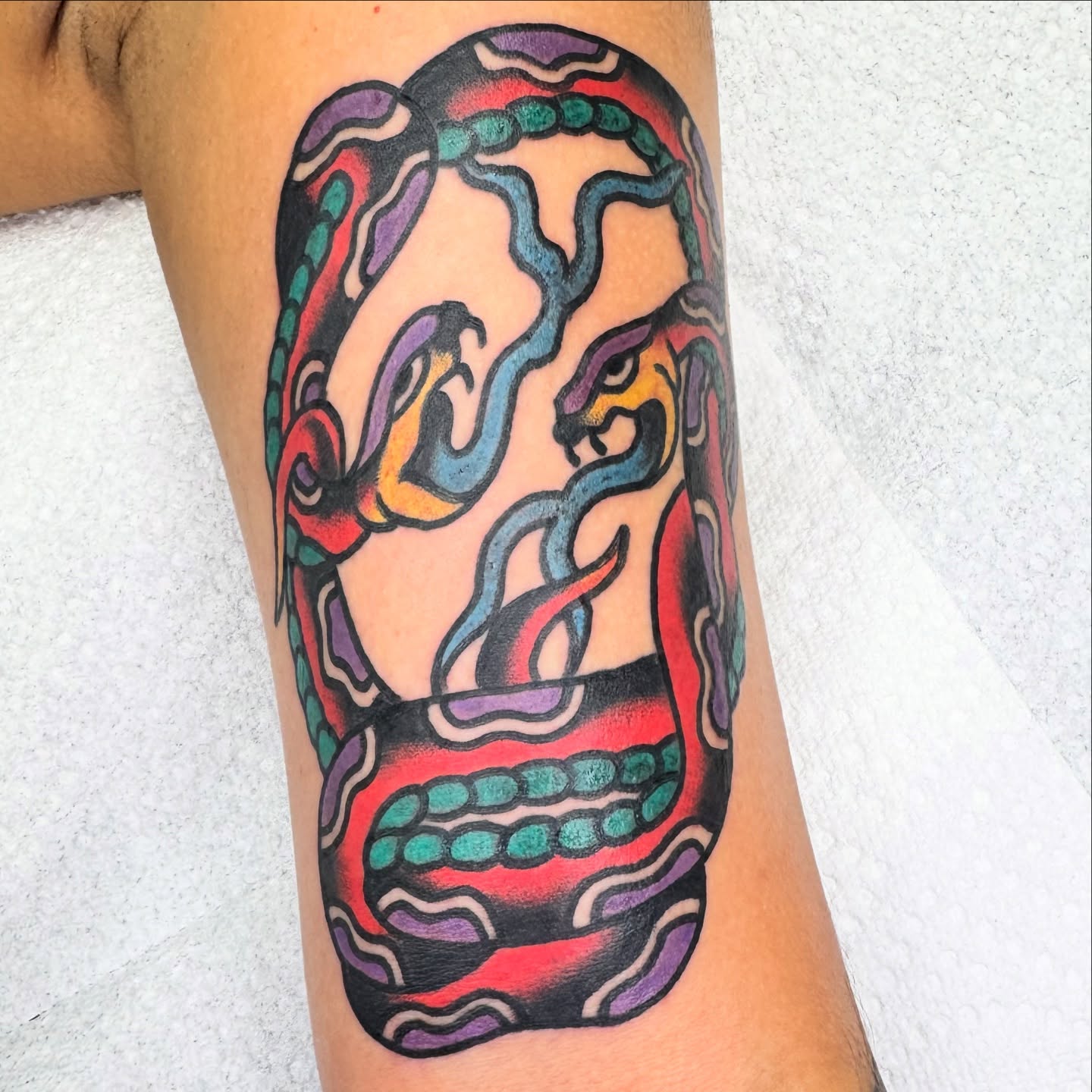 Mask American traditional tattoo on the forearm by Kenny Kastro
