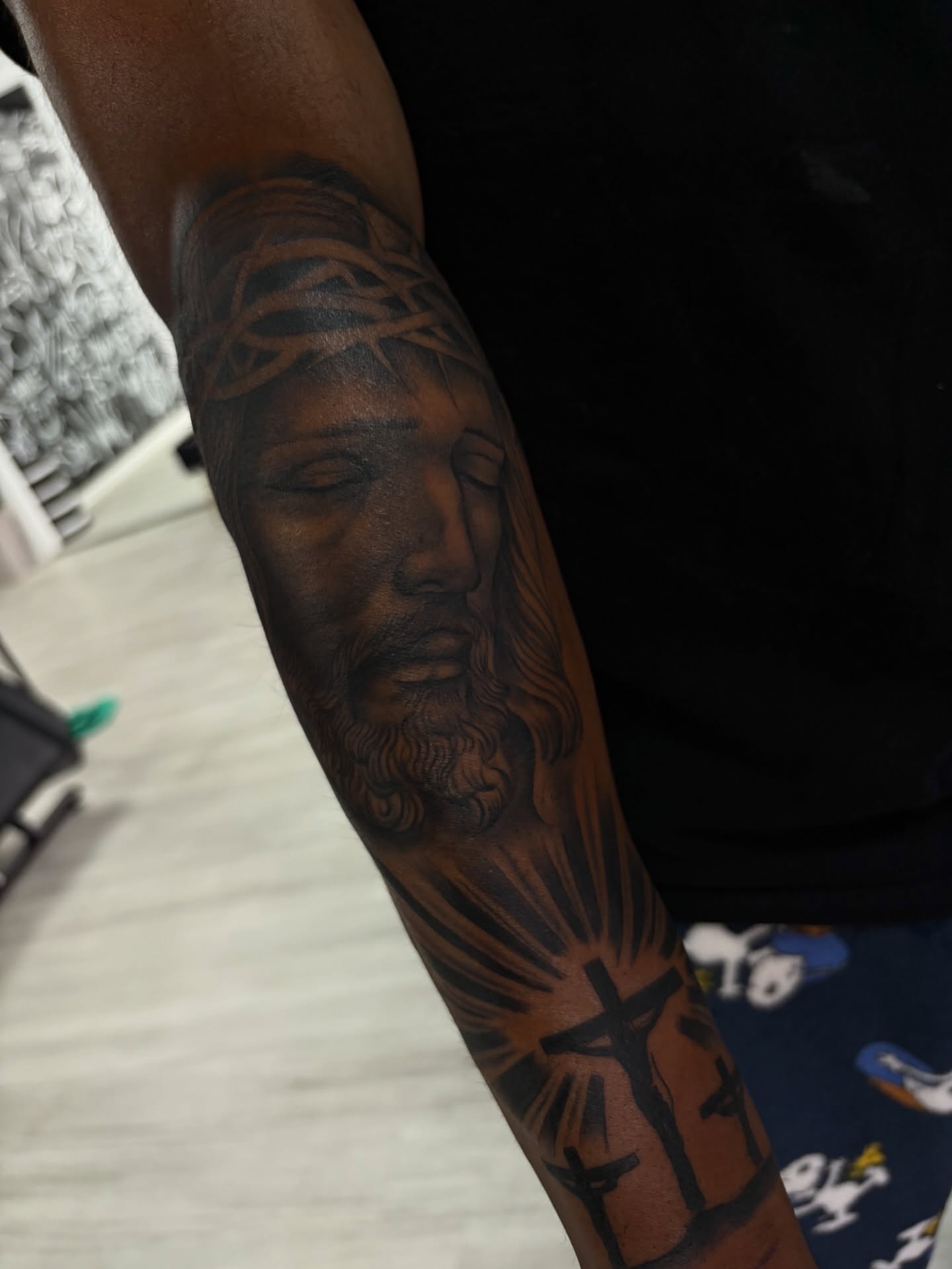 Religious figure realism tattoo on the forearm by Savannah Tattoo Artist