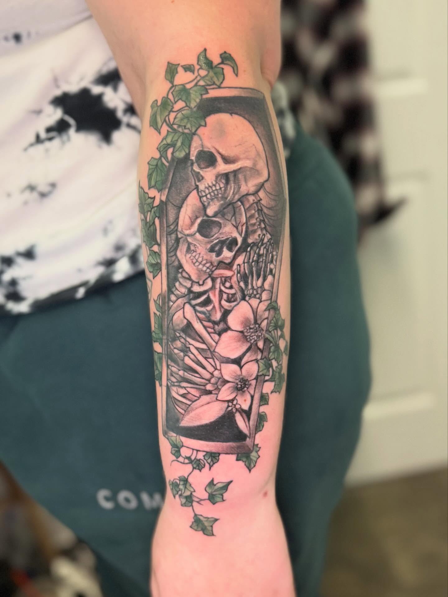 Skeletons and flowers realism tattoo on the forearm by Vega