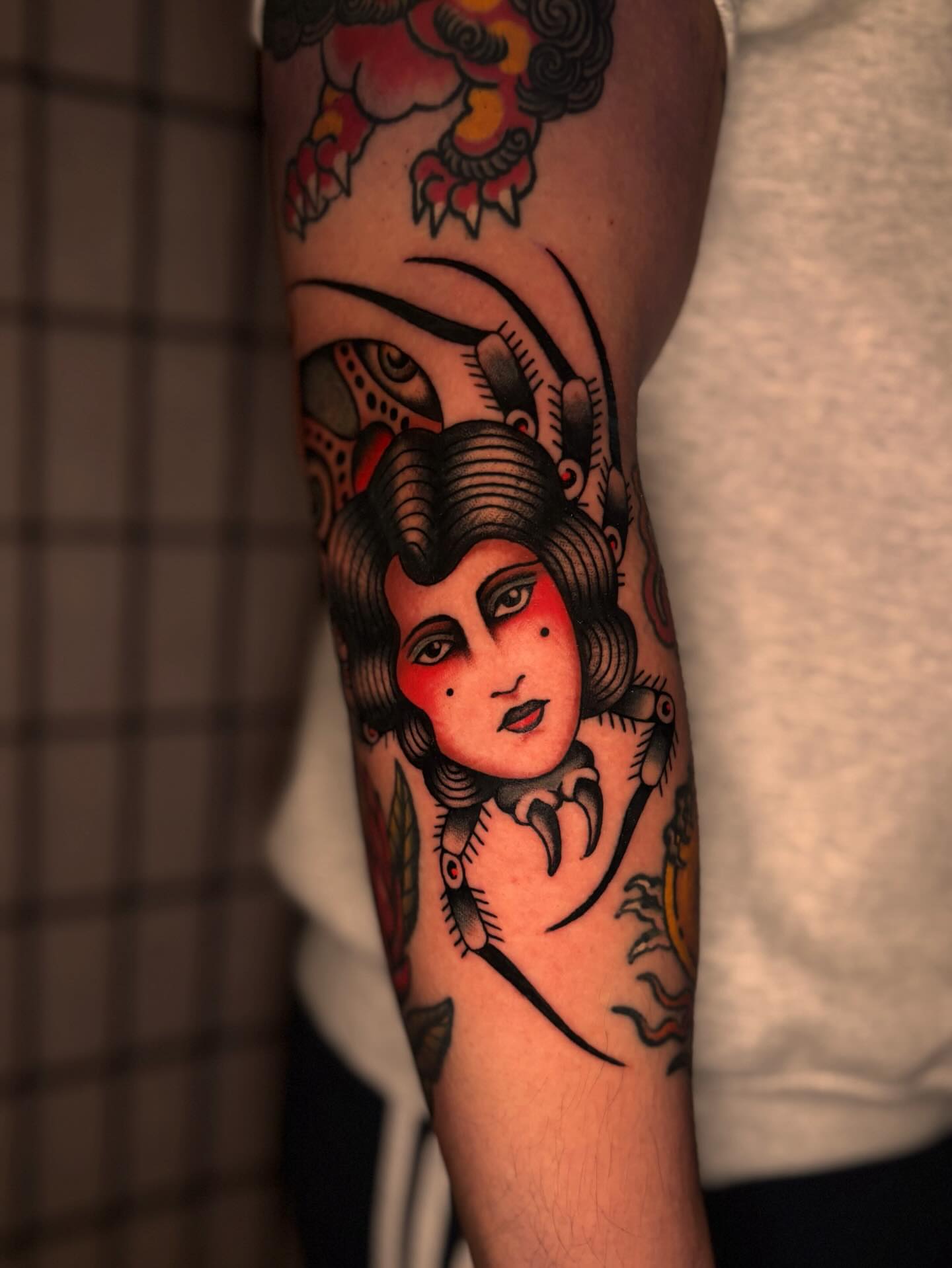 Woman's face American traditional tattoo on the forearm by Jesse Smith, Chicago, Illinois