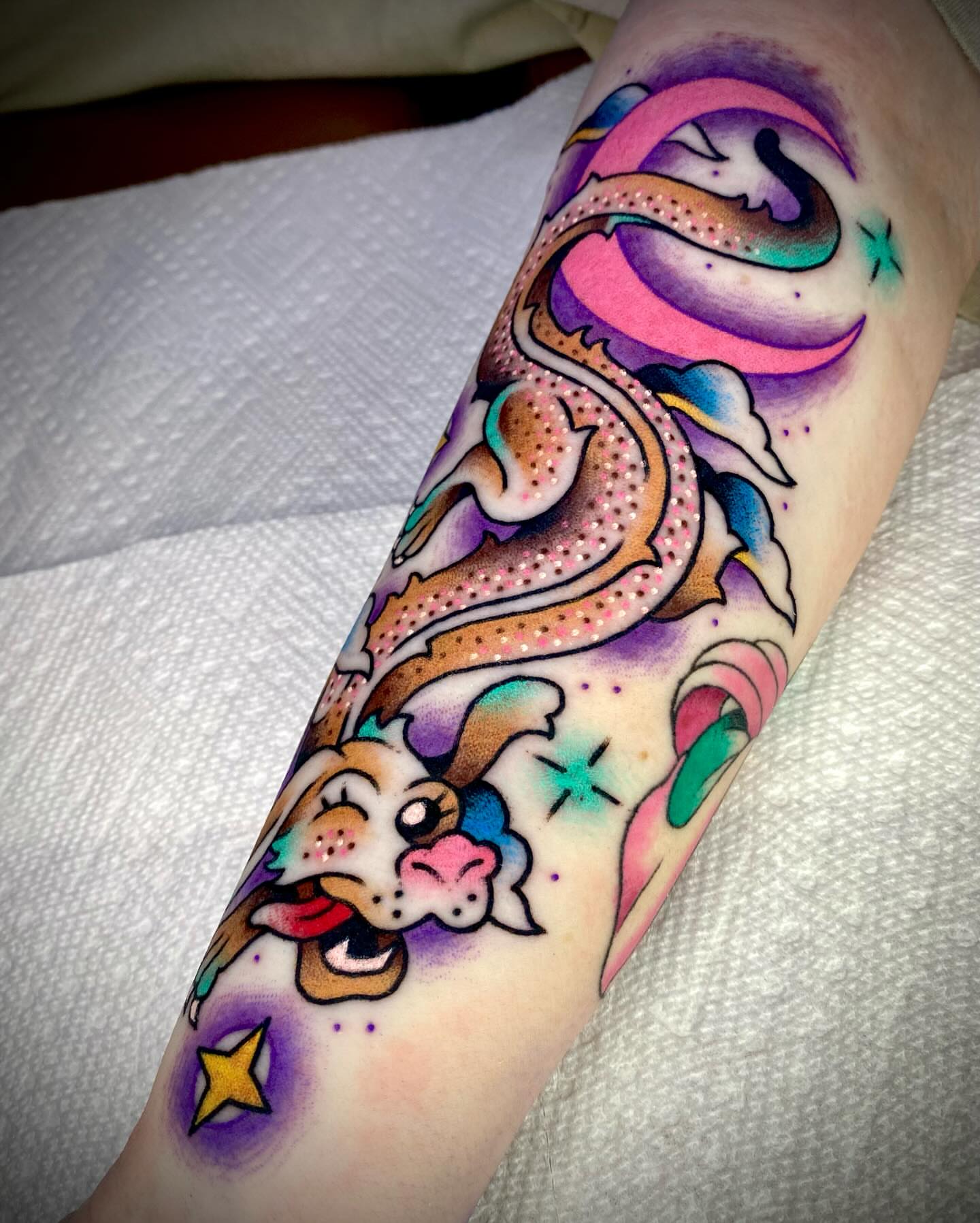 Dragon and celestial elements dotwork tattoo on the forearm by Zach Knisley (Wiz)