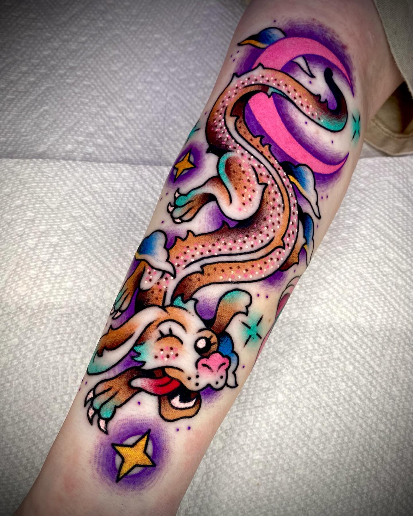 Dog and dragon American traditional tattoo on the forearm by Zach Knisley (Wiz)