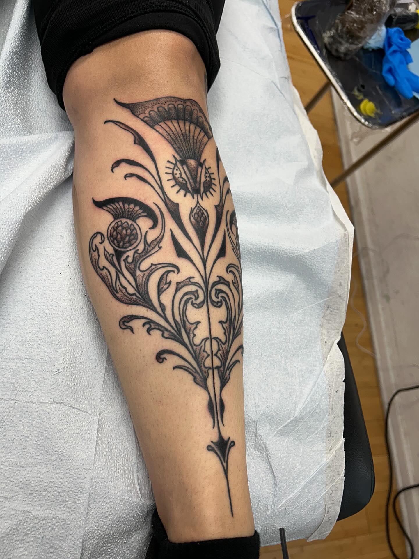 Floral design black and grey tattoo on the forearm by Matthew Crimson