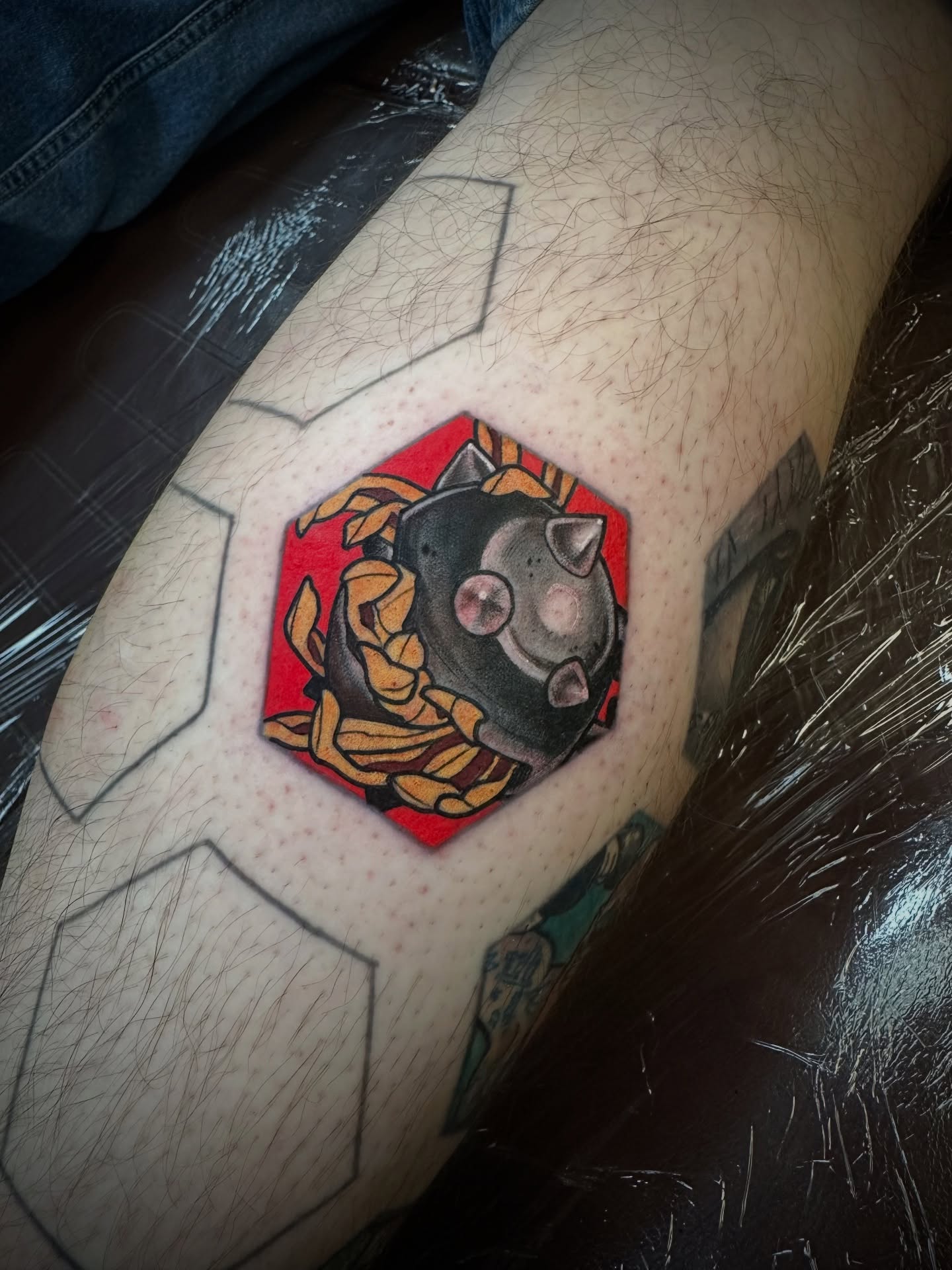 Cat geometric tattoo on the forearm by Teddi Garson
