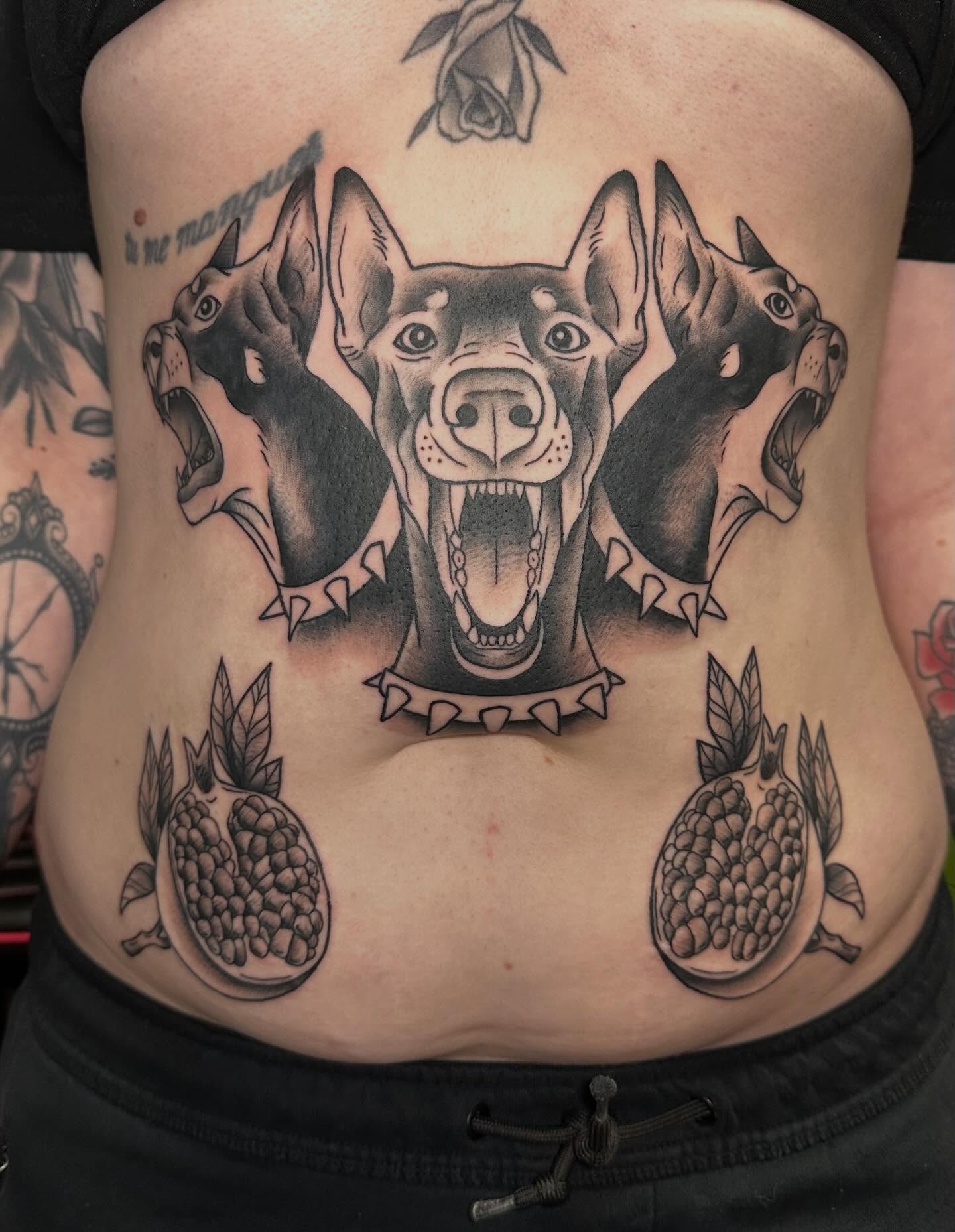 Dogs and pomegranates realism tattoo on the ribs by Tattoo artist
