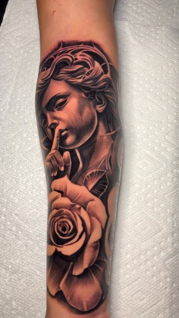 Statue and rose realism tattoo by Isaac Barrientos