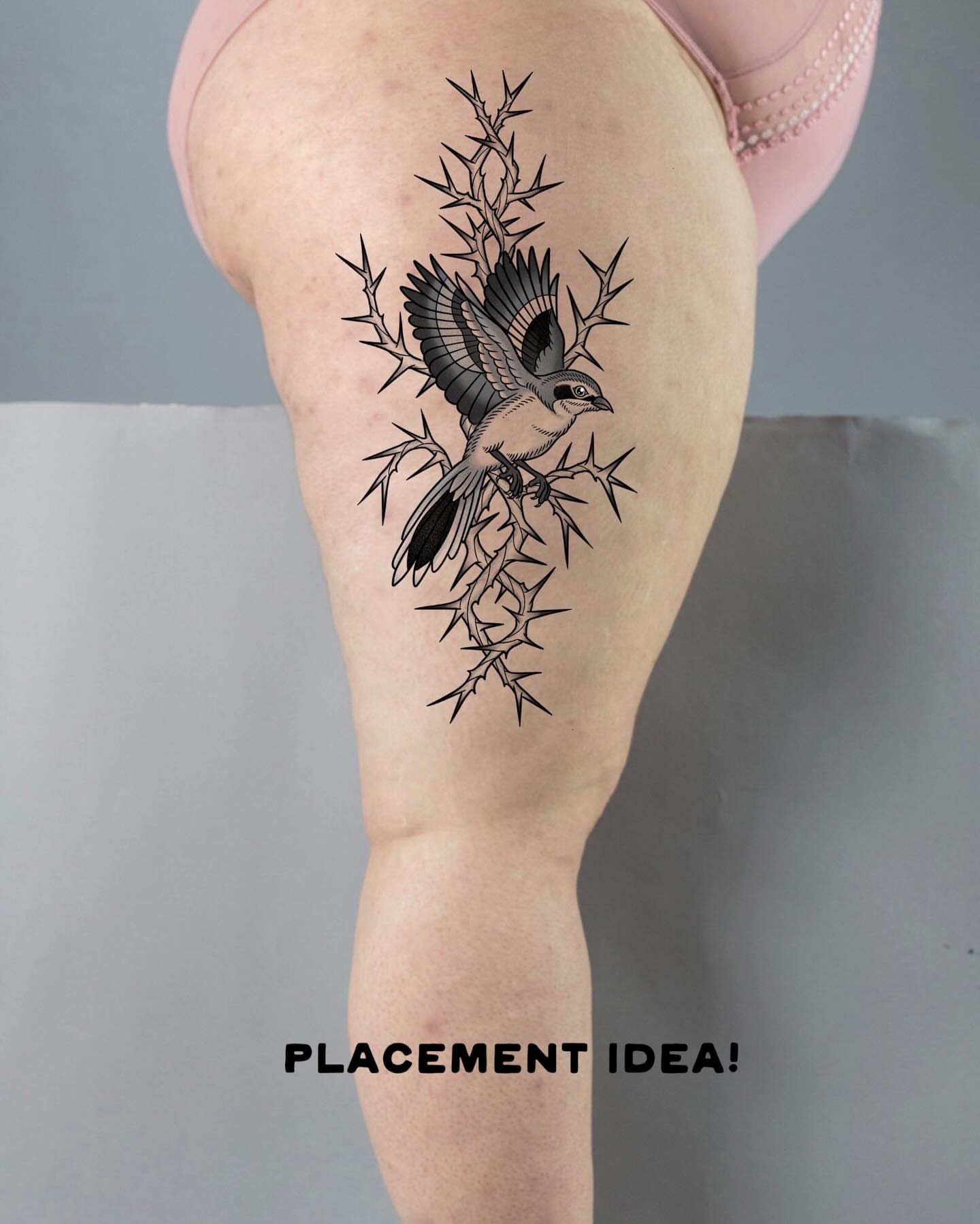Bird and thorns black and grey tattoo on the thigh by Krista - Tattoo Artist