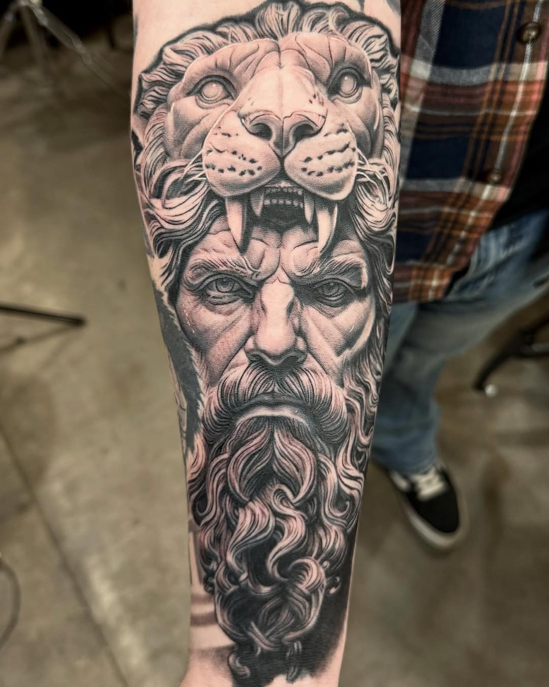 Hercules wearing the Nemean lion skin surrealism tattoo on the forearm by Jayden A