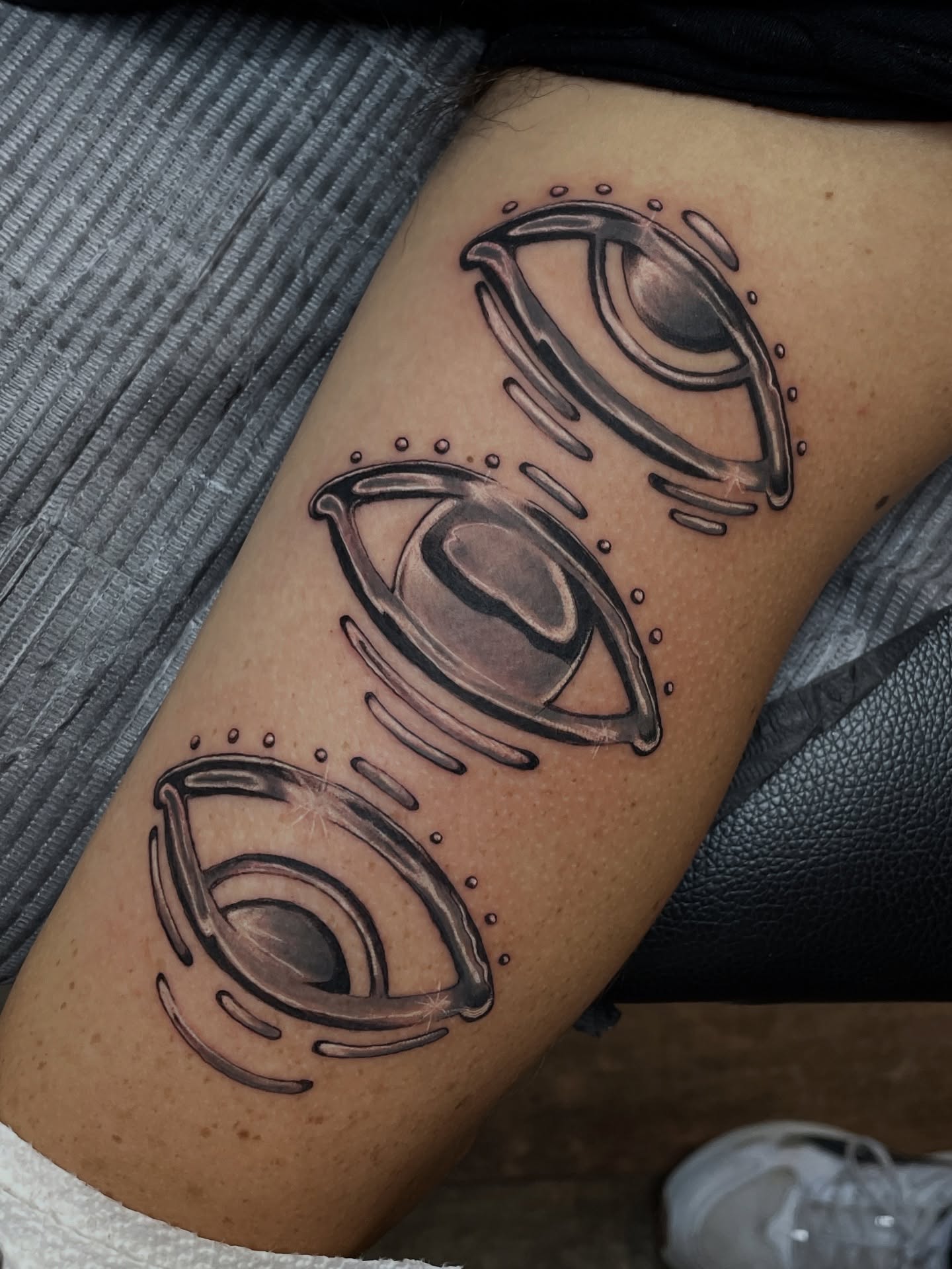 Eye black and grey tattoo on the thigh by Tanya Murski