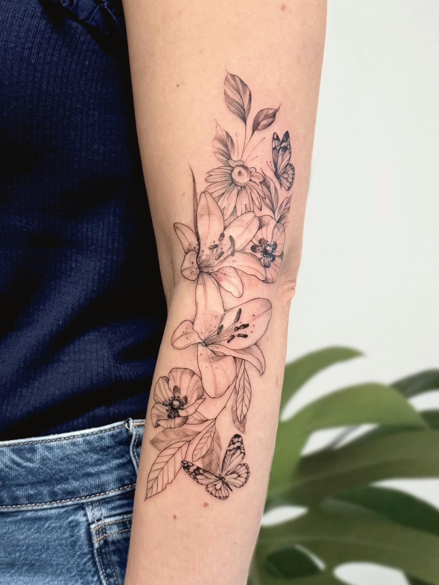 Floral arrangement realism tattoo on the forearm by Marianna D D King