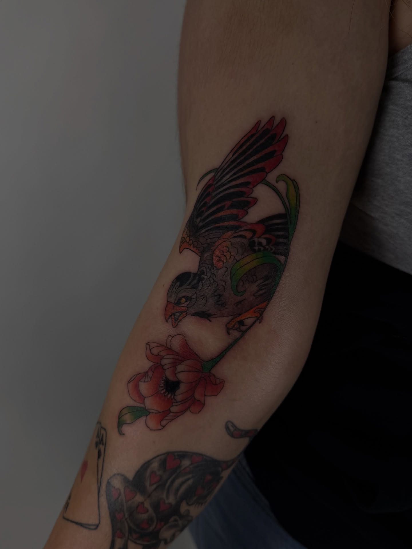 Bird and flower American traditional tattoo on the forearm by sabina