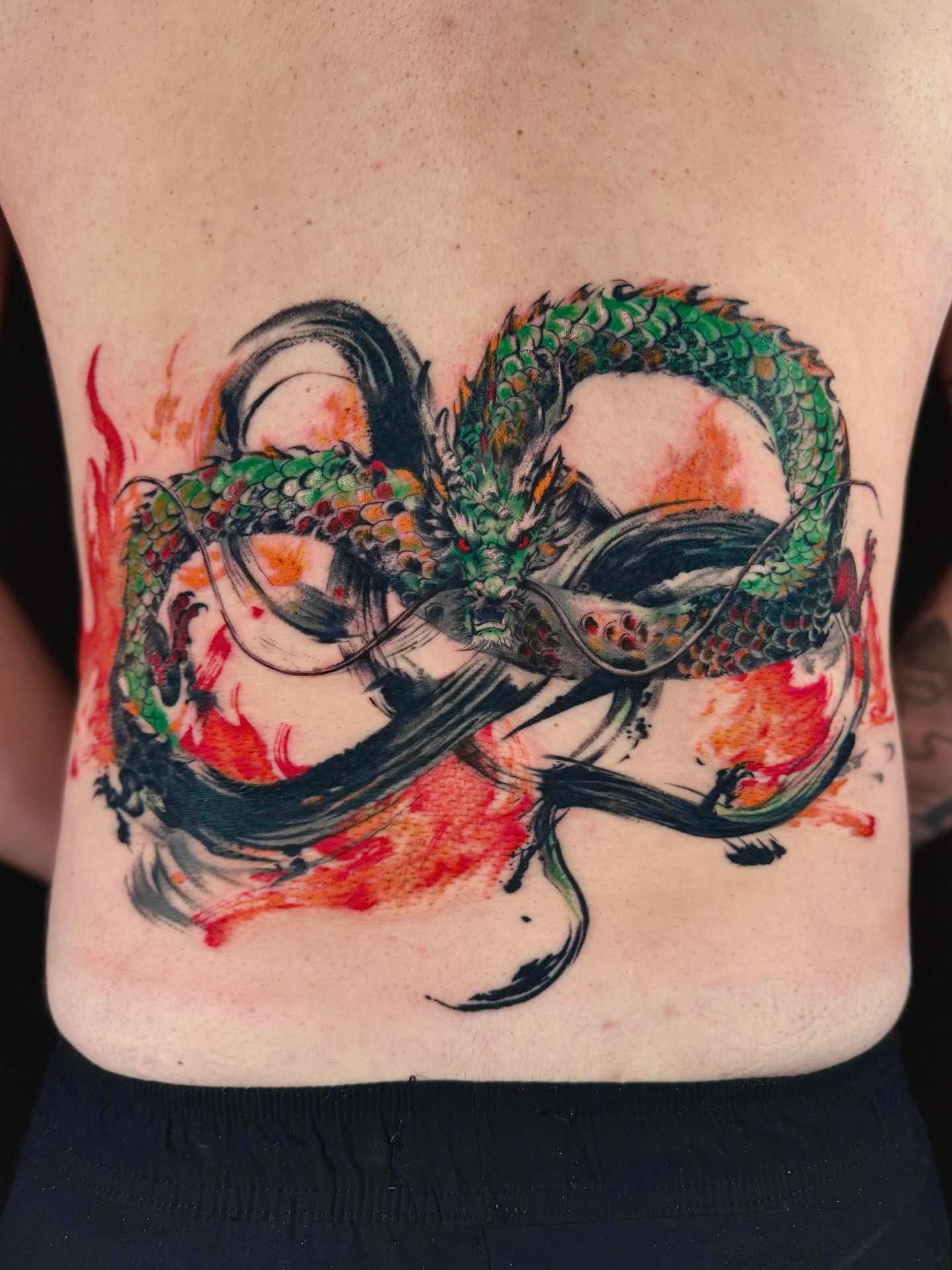 Dragon watercolor tattoo on the back by Abi