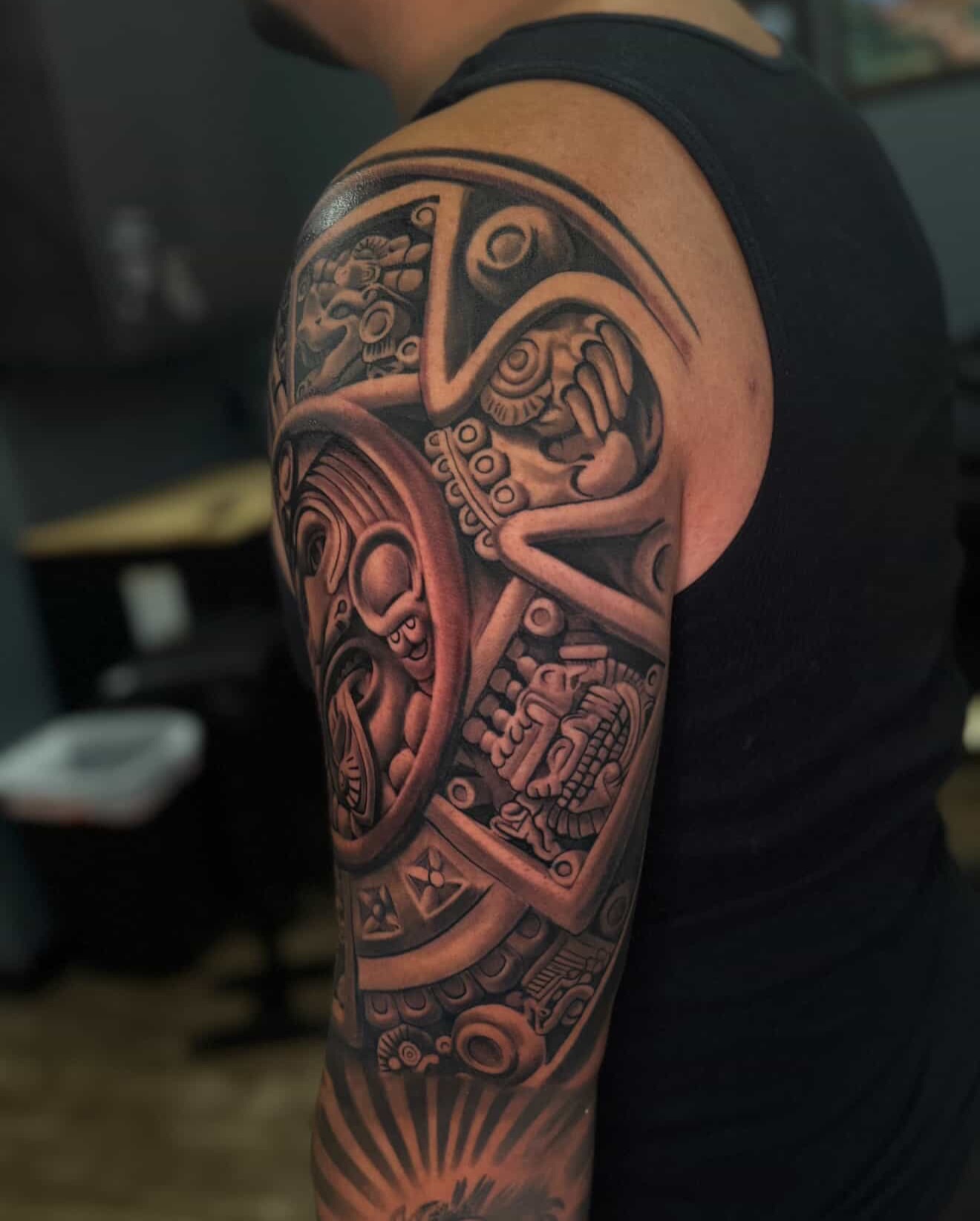 Mechanical gears and figures geometric tattoo on the upper arm by Jose Mendoza Torres