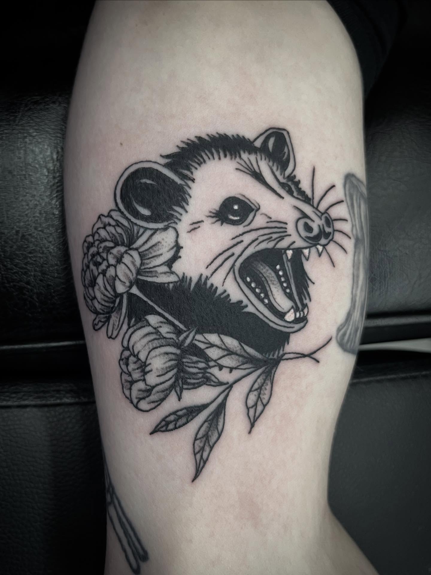 Possum with flowers black and grey tattoo on the forearm by Sean Gallagher