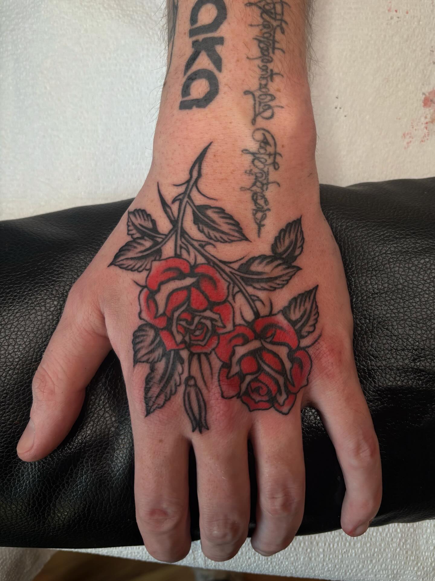 Roses American traditional tattoo on the hand by Lily, Eugene, Oregon