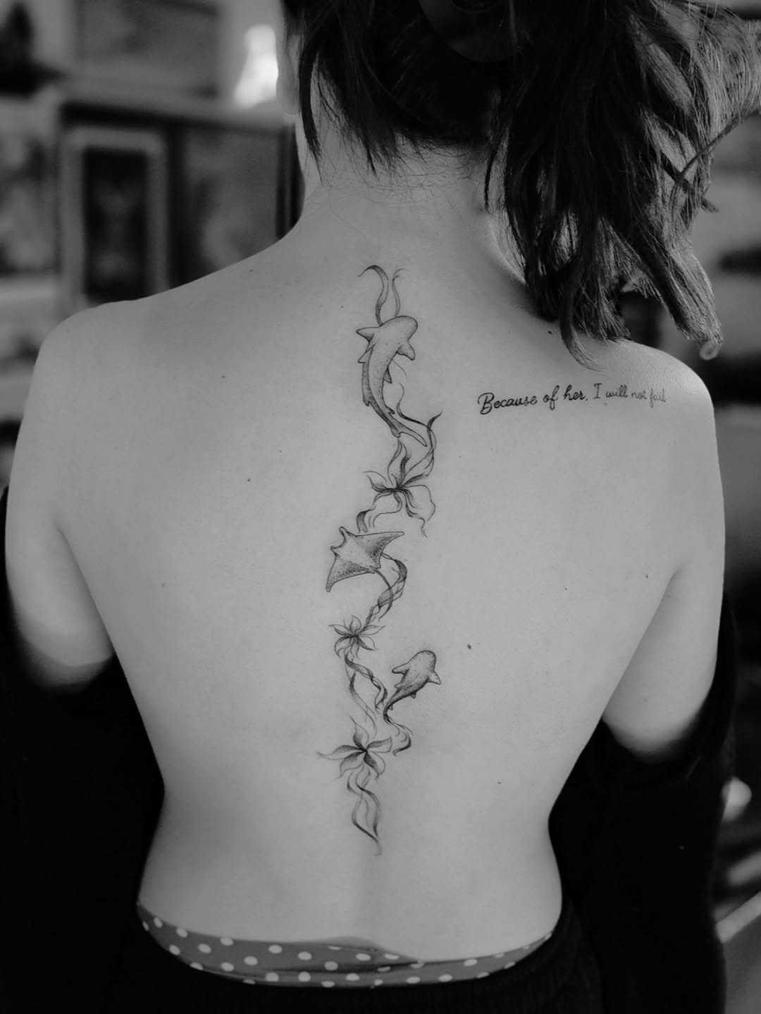 Dolphins and flowers black and grey tattoo on the back by Luke Jordan Ink, Louisville, Colorado